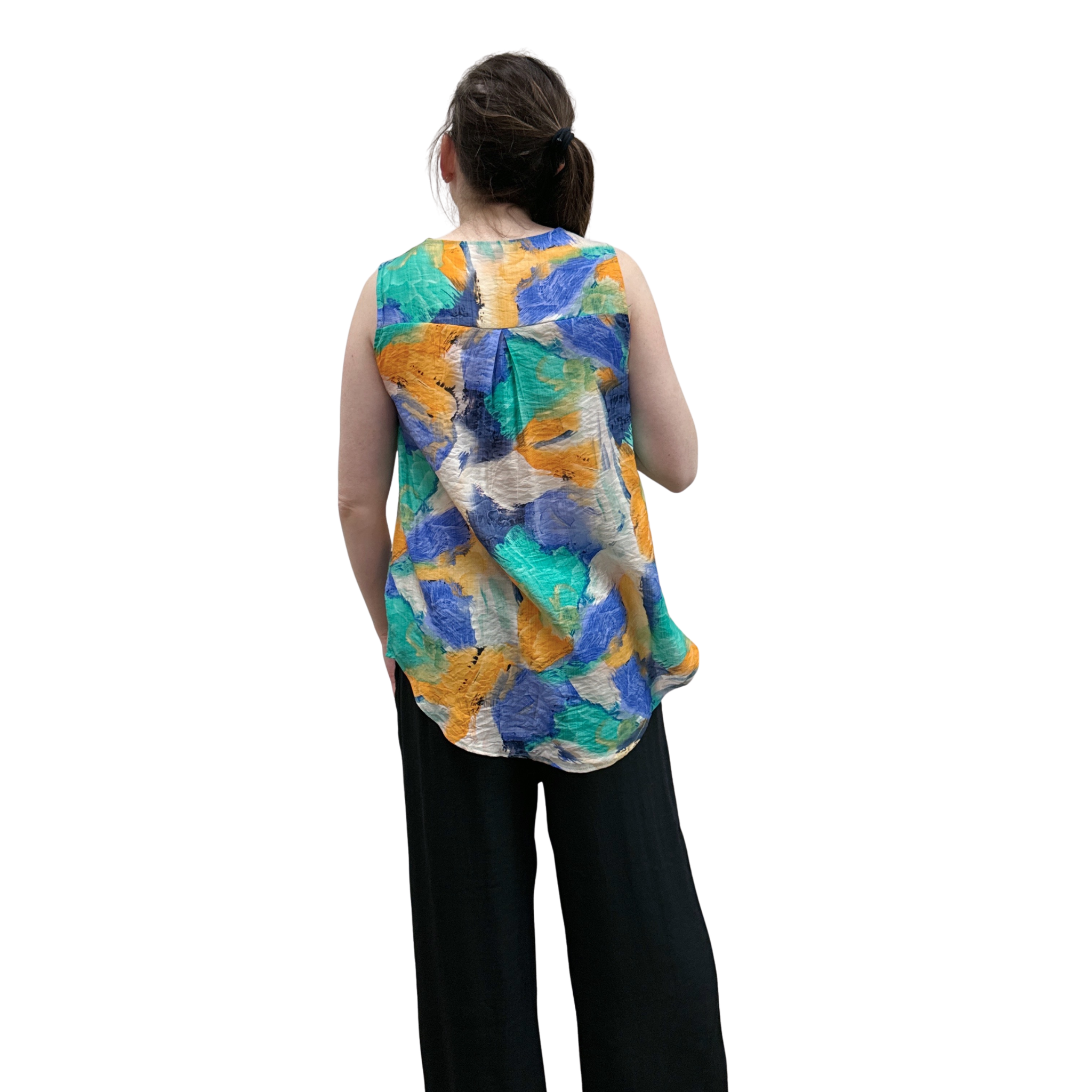Person wearing a colorful sleeveless top with abstract patterns on a white background