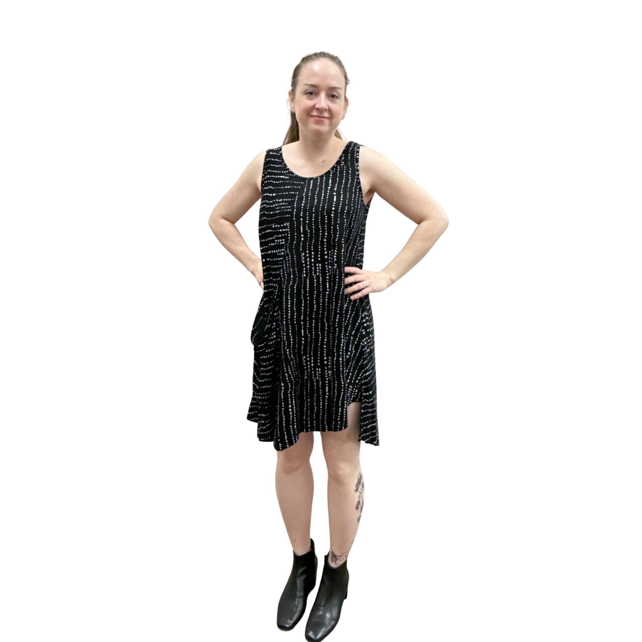 Woman wearing a black dress with white patterns on a white background