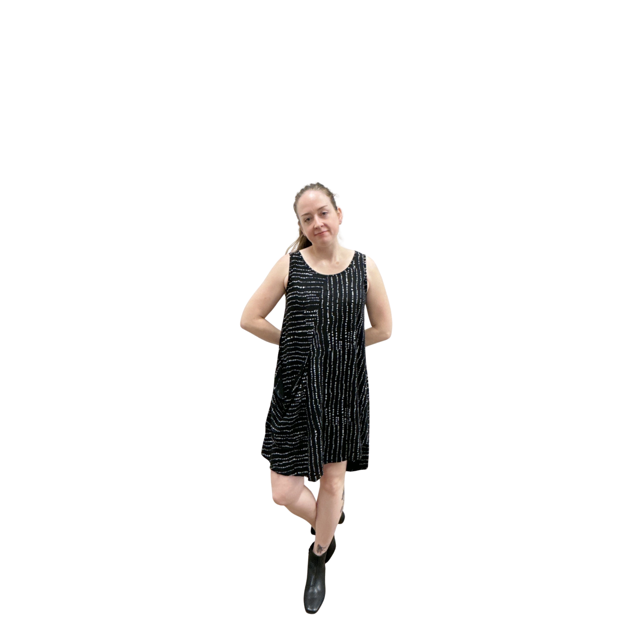 Woman wearing a black and white patterned dress on a white background