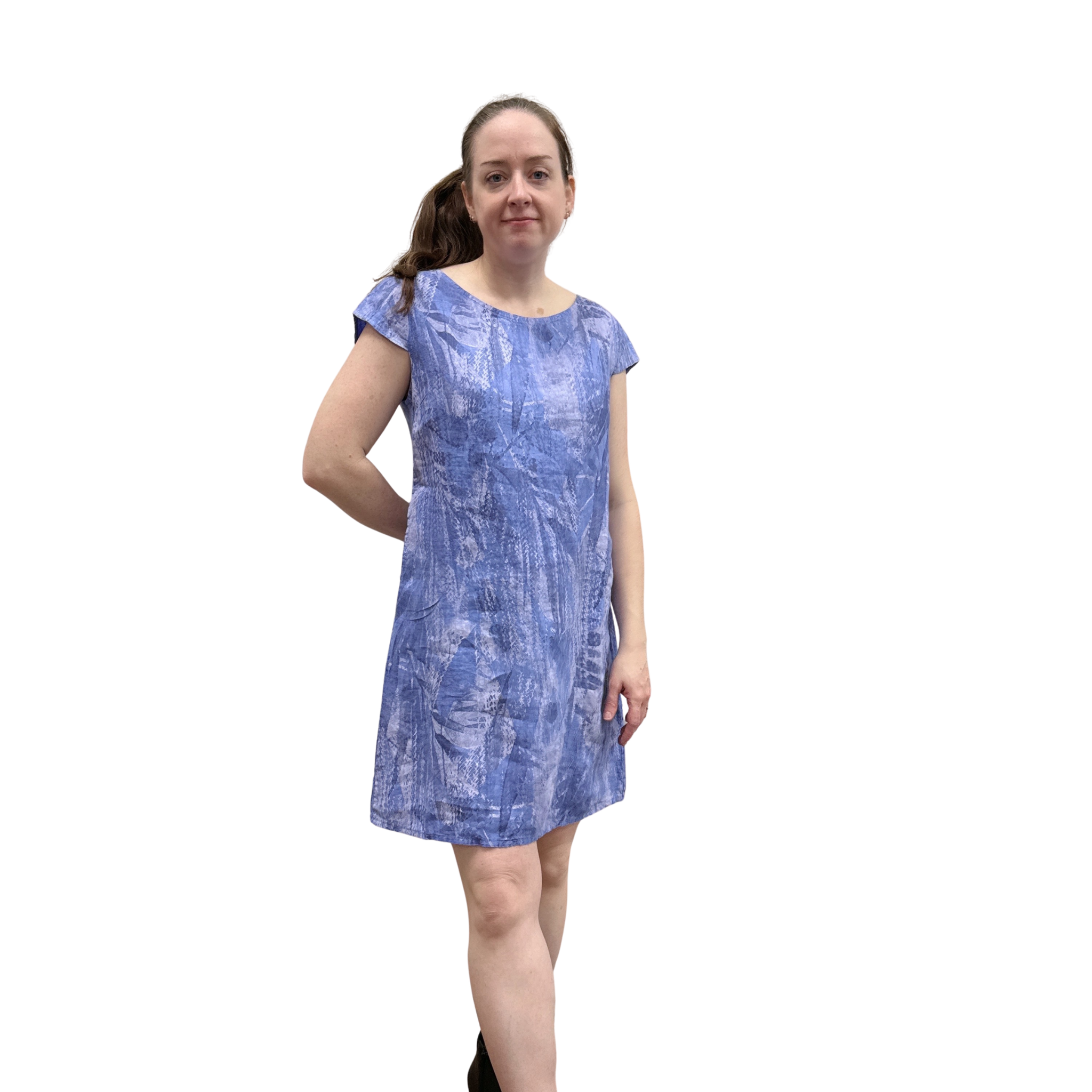 Woman wearing a blue patterned dress on a white background