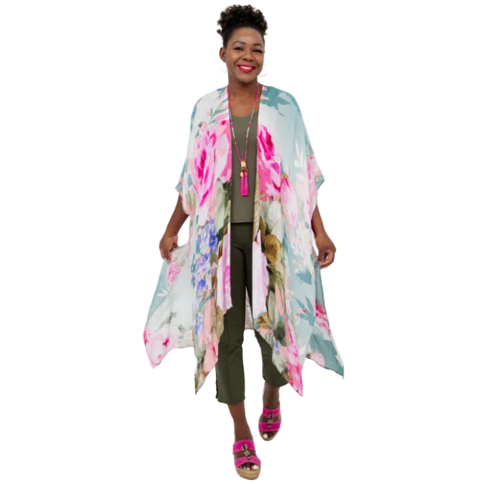 Woman wearing a blue sky clothing darcy kimono in rosa print on a white background