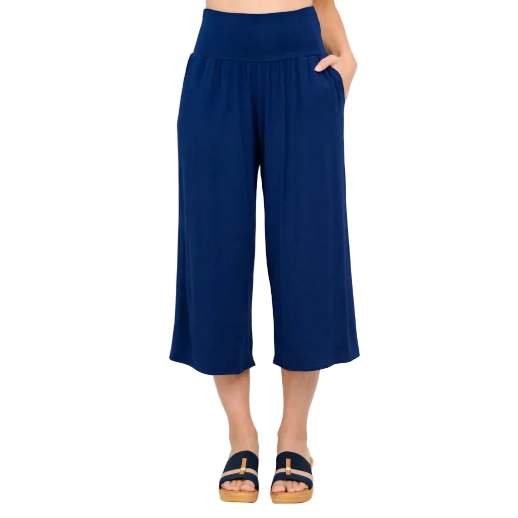 Close up of model wearing Blue Sky Clothing Gaylene Capri in indigo on white background