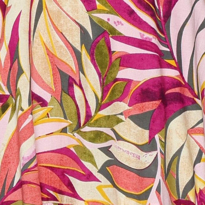 Close up of the print on the papa classic print cap sleeve dress with a pink palm leaf pattern and ruffled bottom