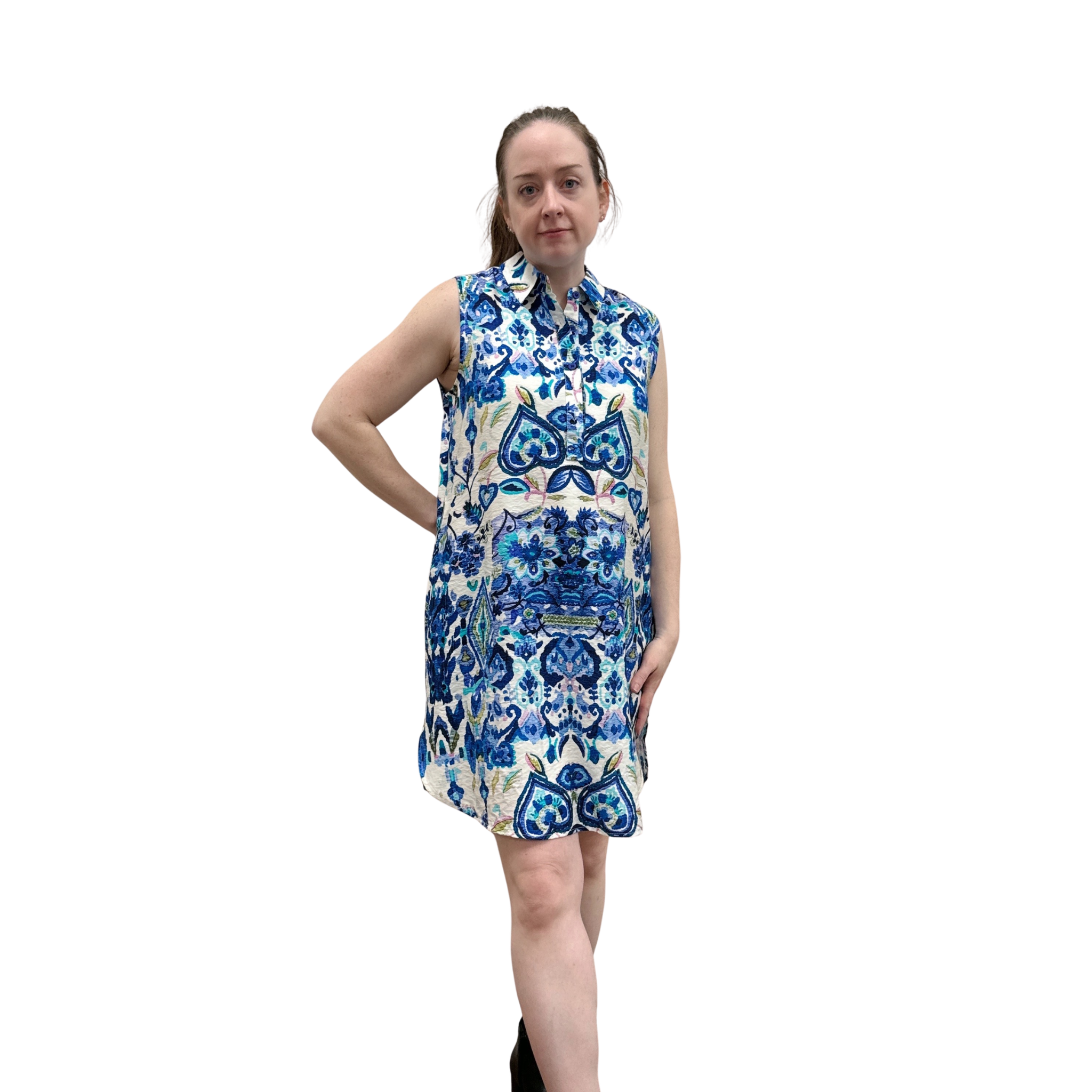 Woman wearing a sleeveless floral dress with blue and white pattern on a white background