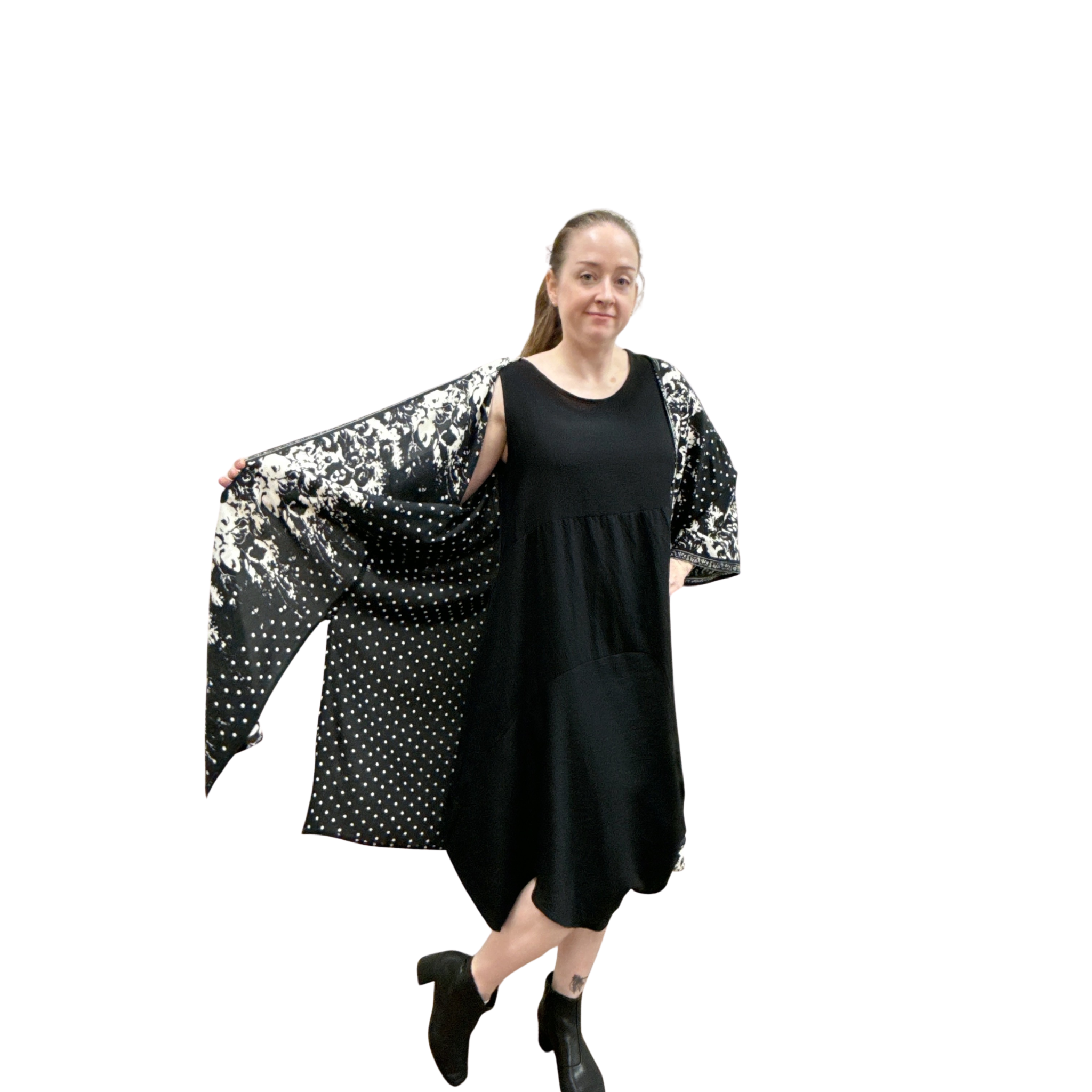 Woman wearing a black dress with a patterned shawl on a white background