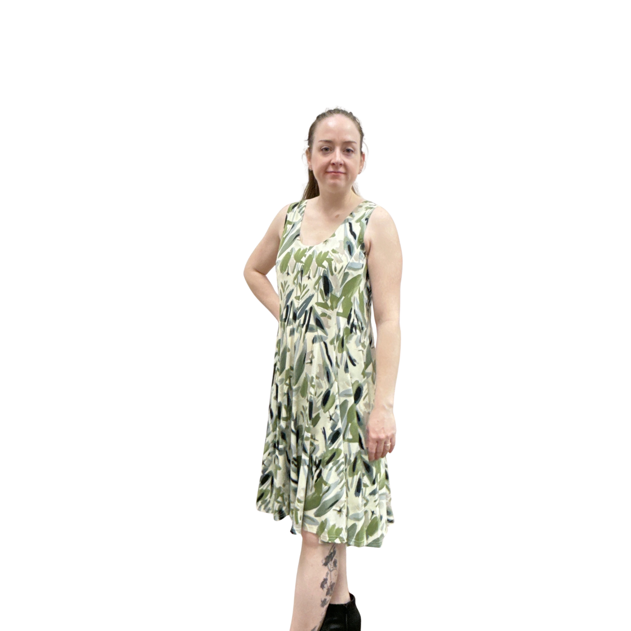 Woman wearing a green leaf-patterned dress on a white background