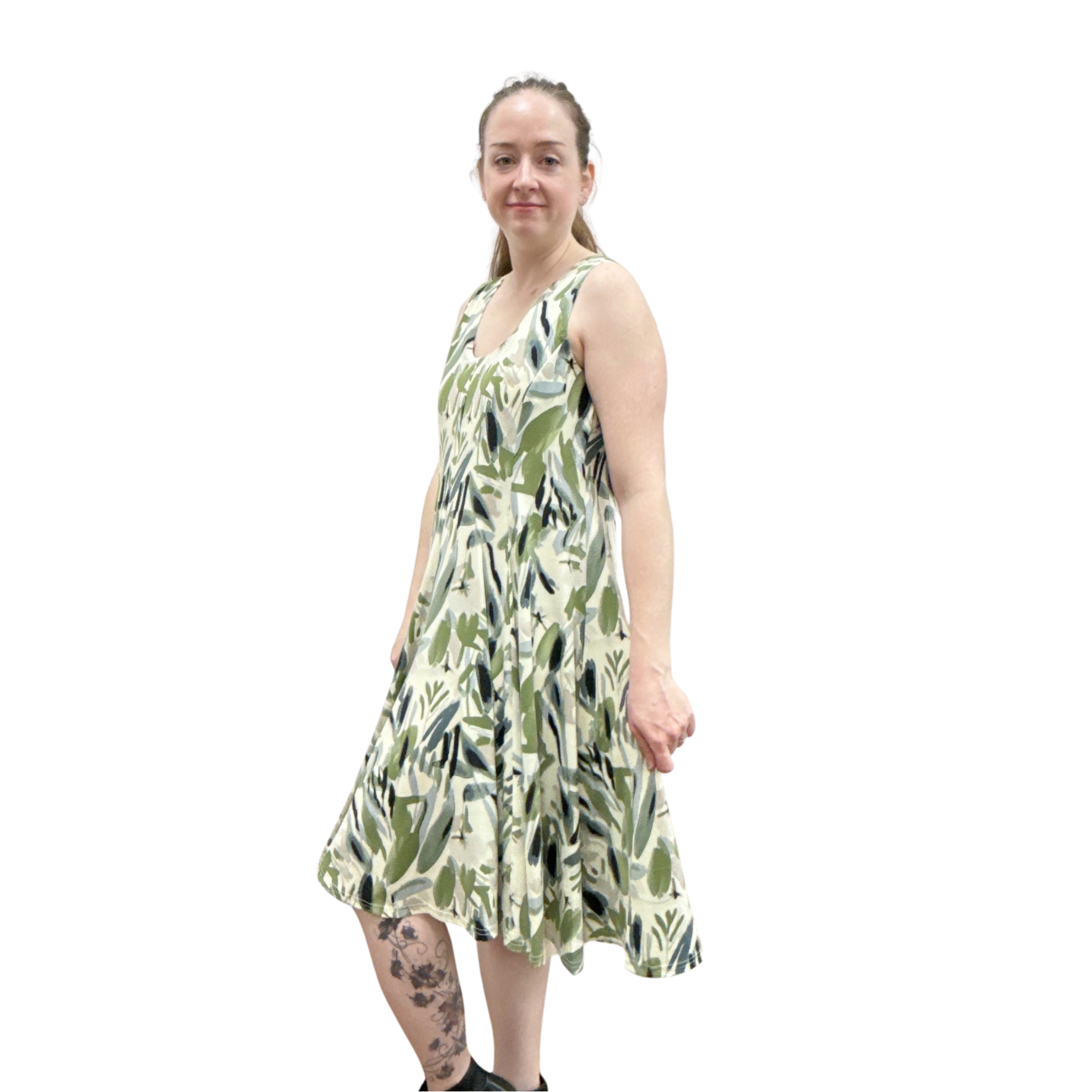 Woman wearing a green and white patterned dress on a white background