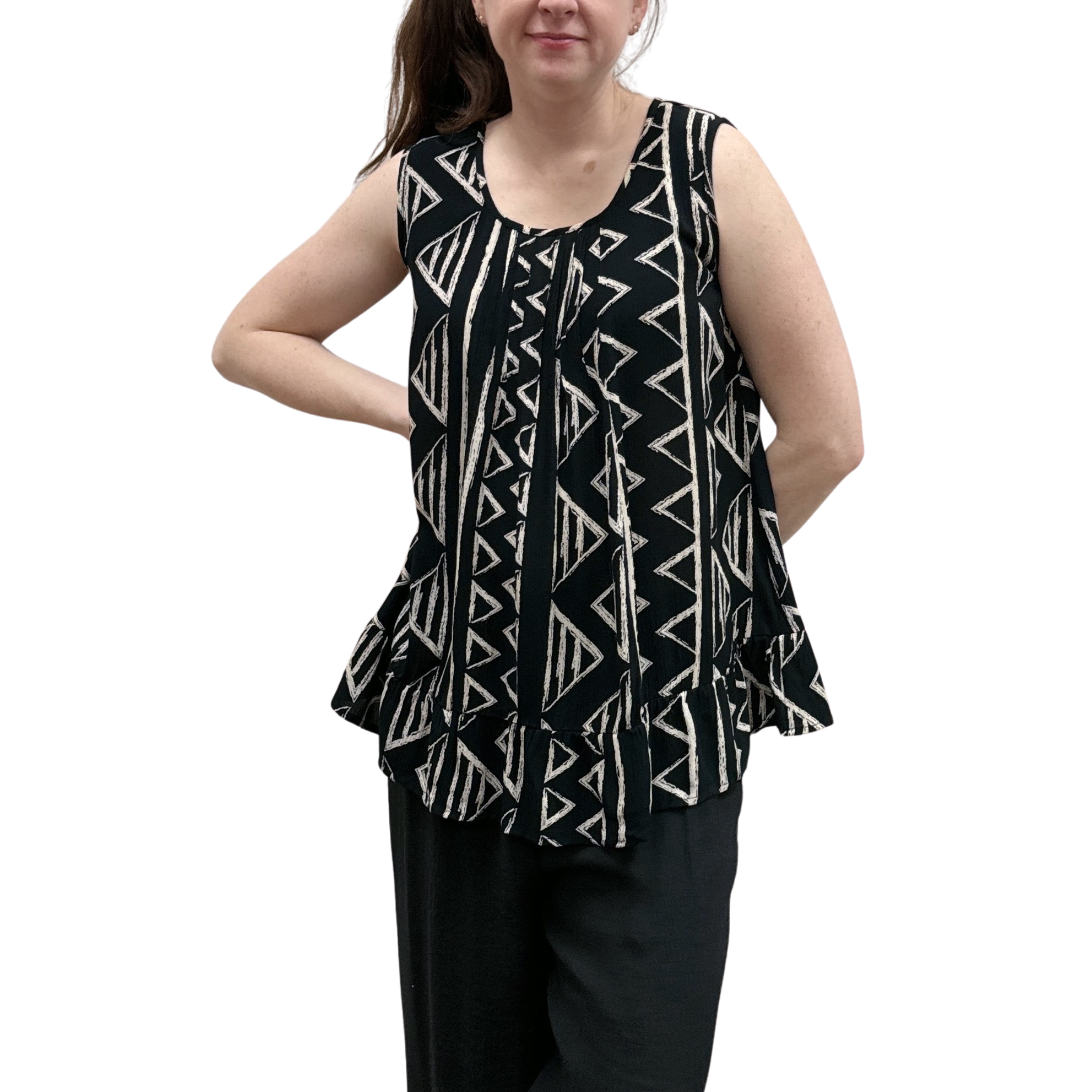 Woman wearing black with geometric print pattern sleeveless top with ruffle bottom on white background