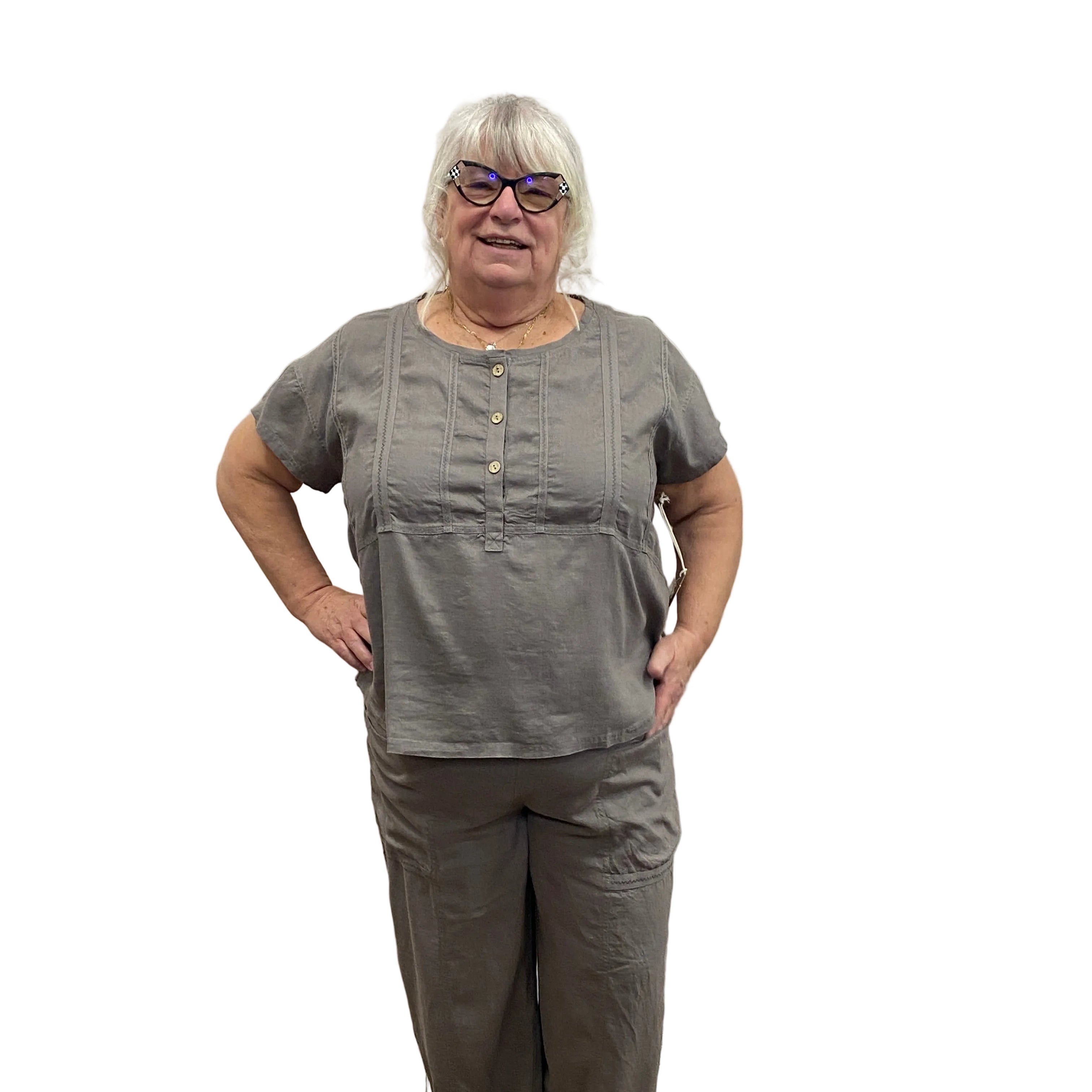 Person wearing a gray Papa Islandscape tee and flood pants on white background.