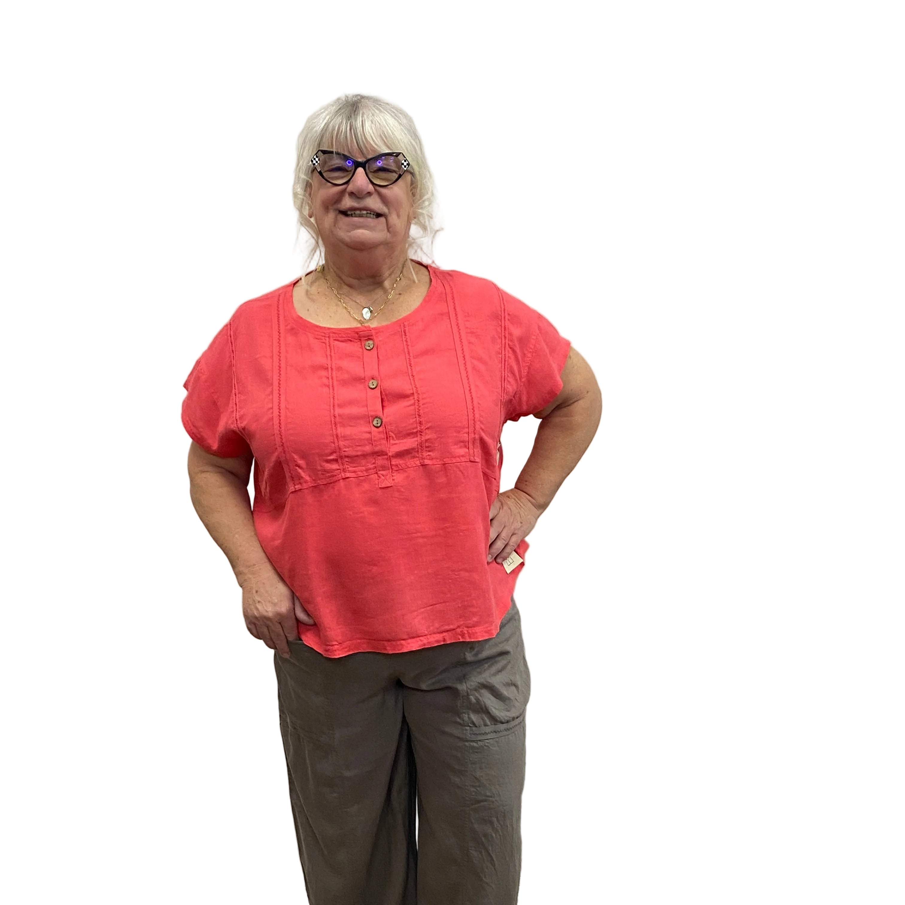 Person wearing a pink Papa Getaway Tee and gray pants on white background.