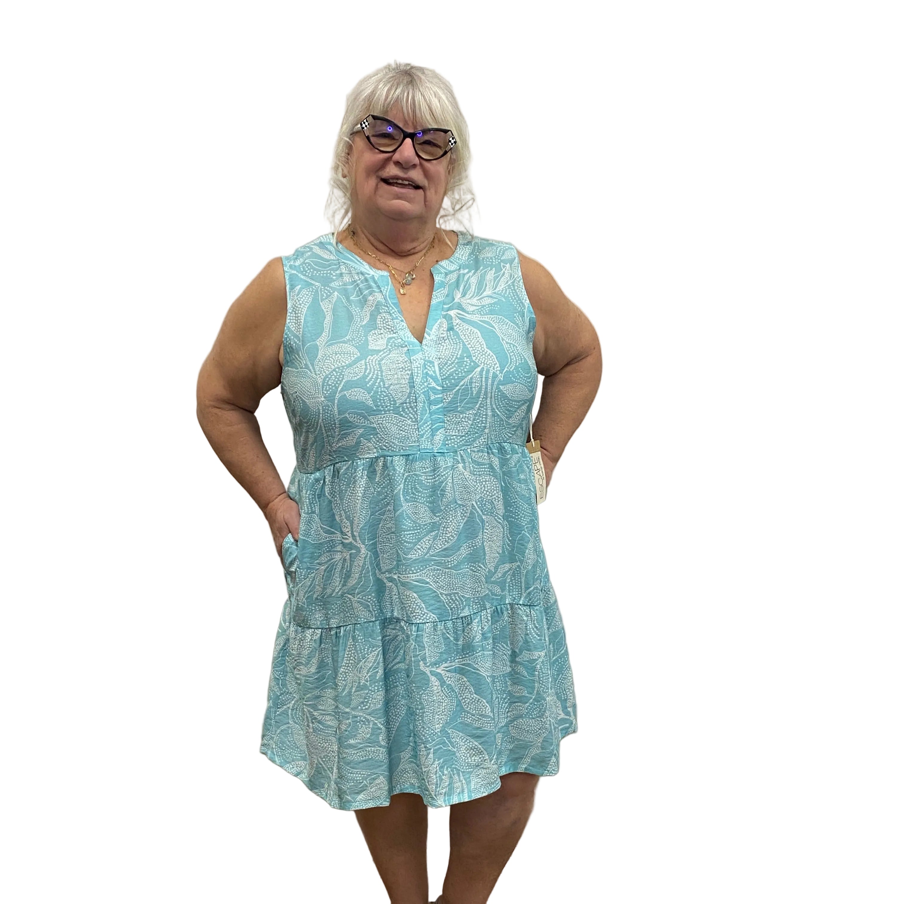 Woman wearing a blue floral dress on white background.