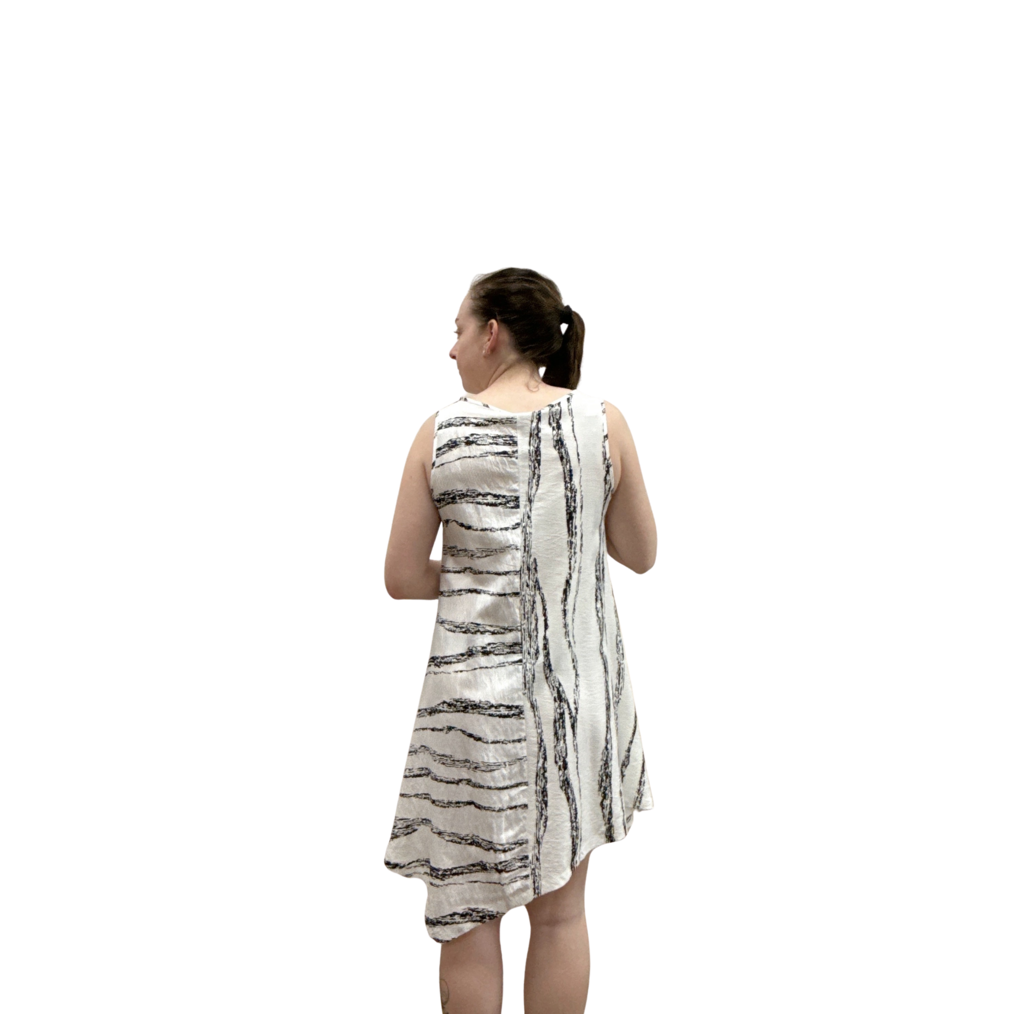 Woman wearing a sleeveless dress with a pattern on a white background