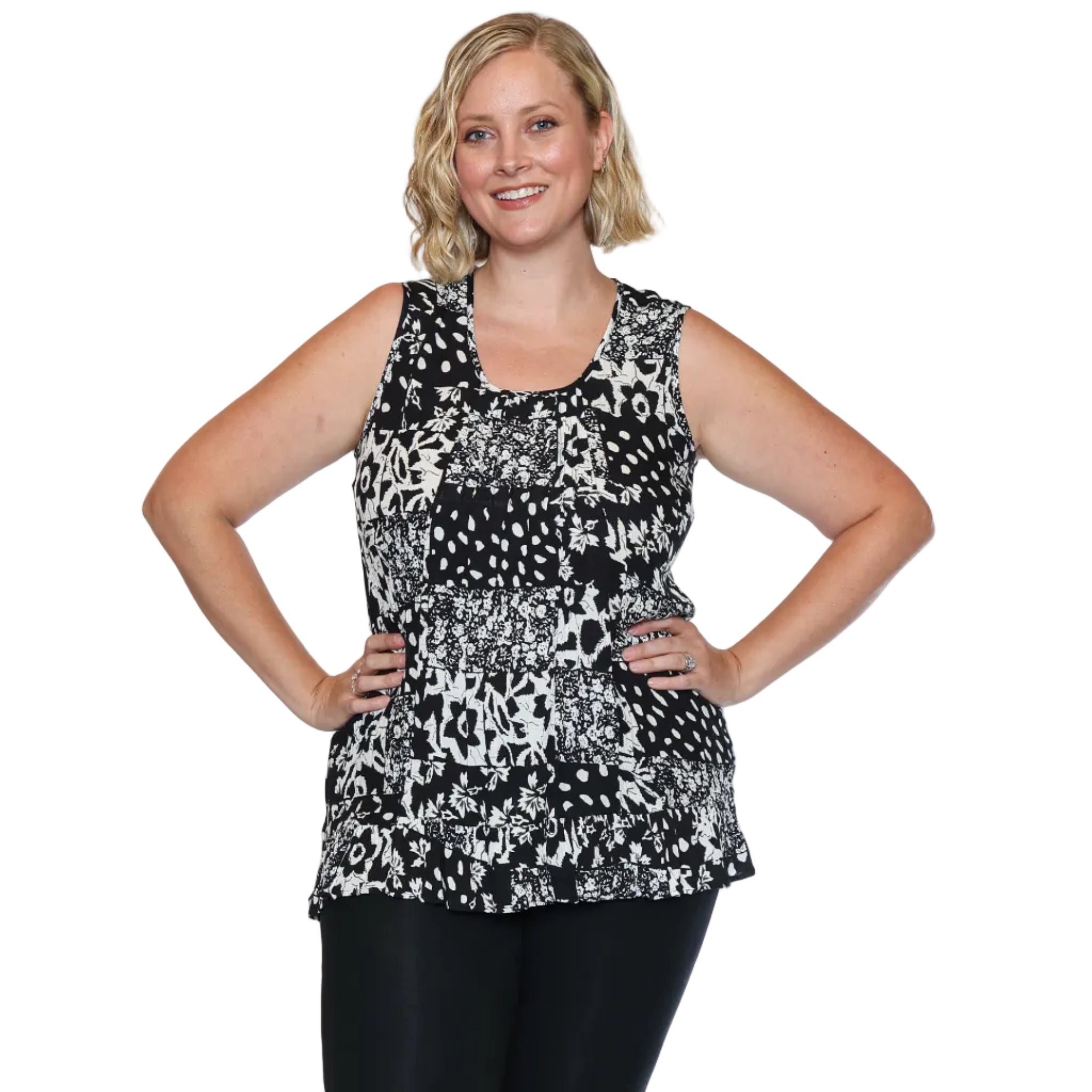 Woman wearing a black and white patterned sleeveless top on a white background