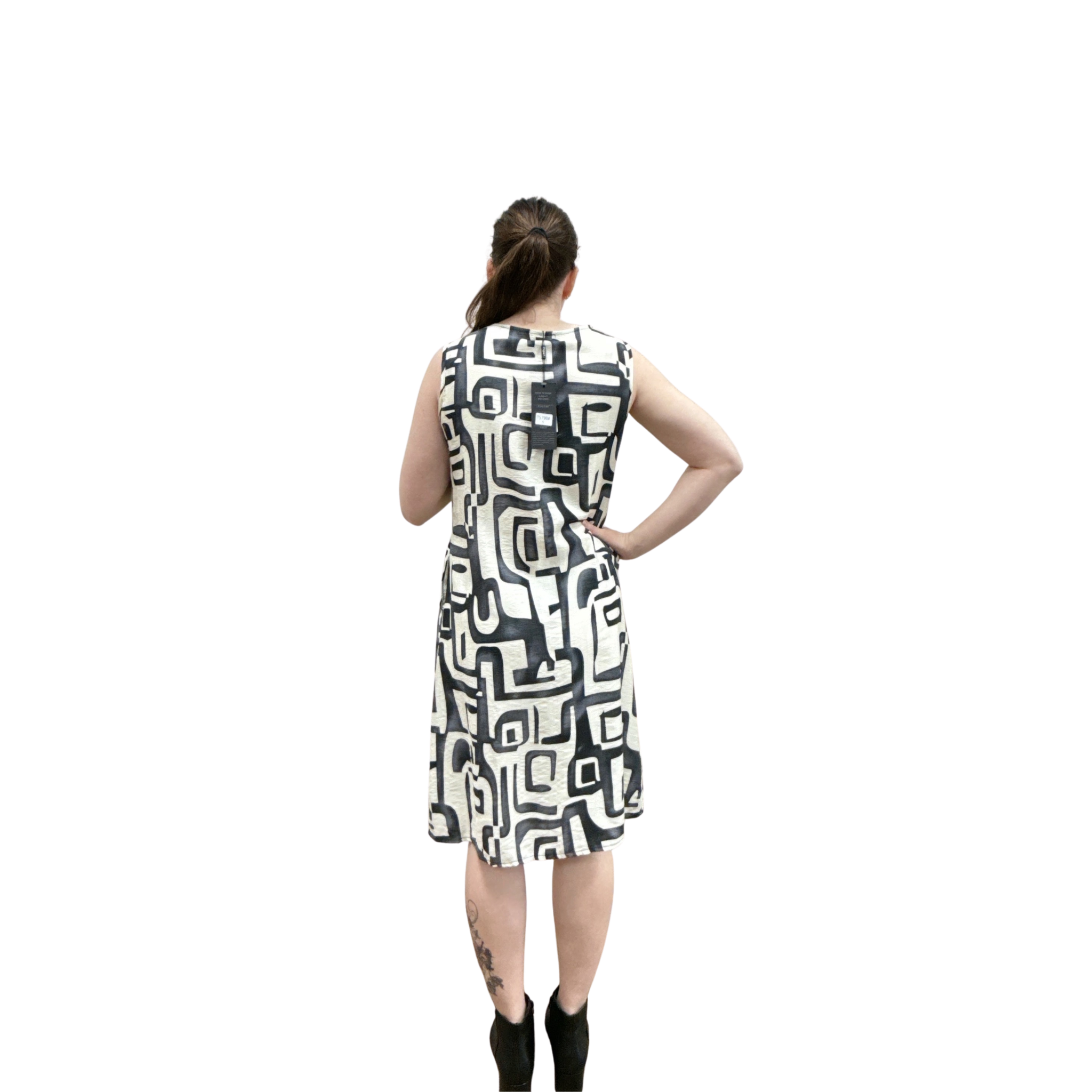 Woman wearing a sleeveless dress with a geometric pattern on a white background