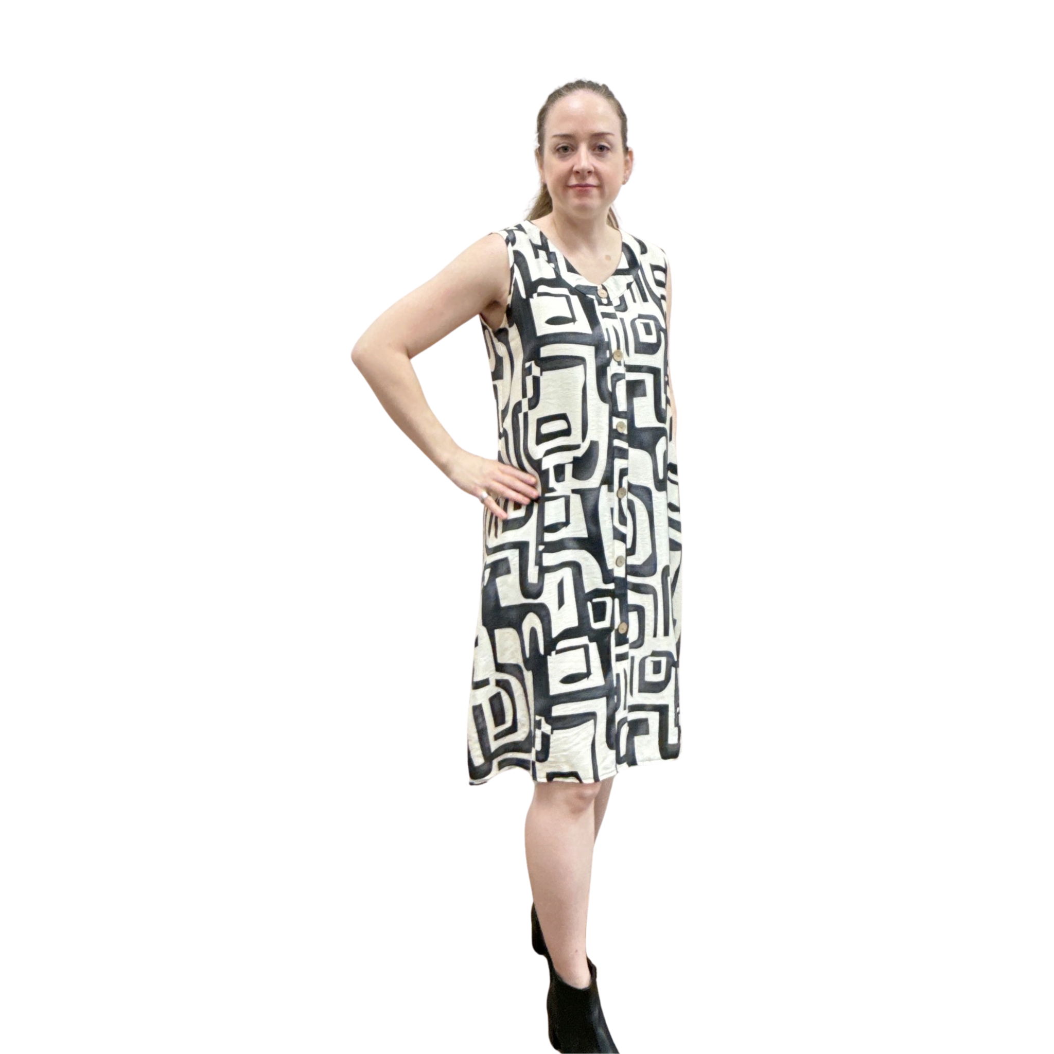 Woman wearing a sleeveless dress with geometric pattern on a white background