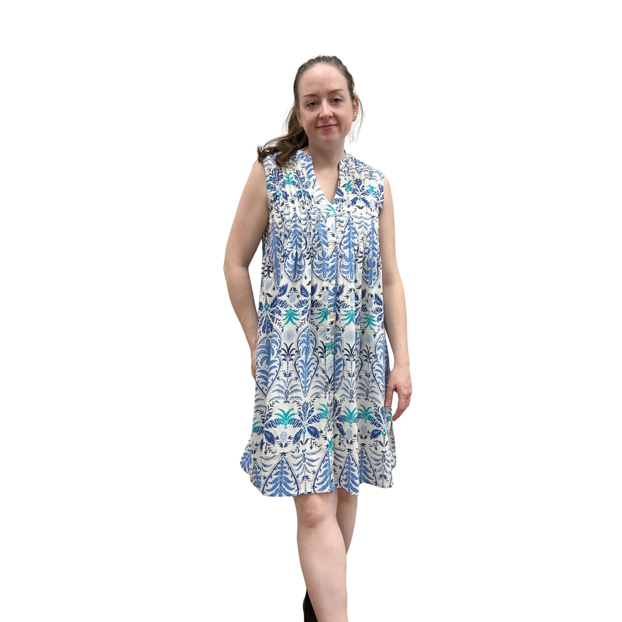 Woman wearing a sleeveless floral dress on a white background