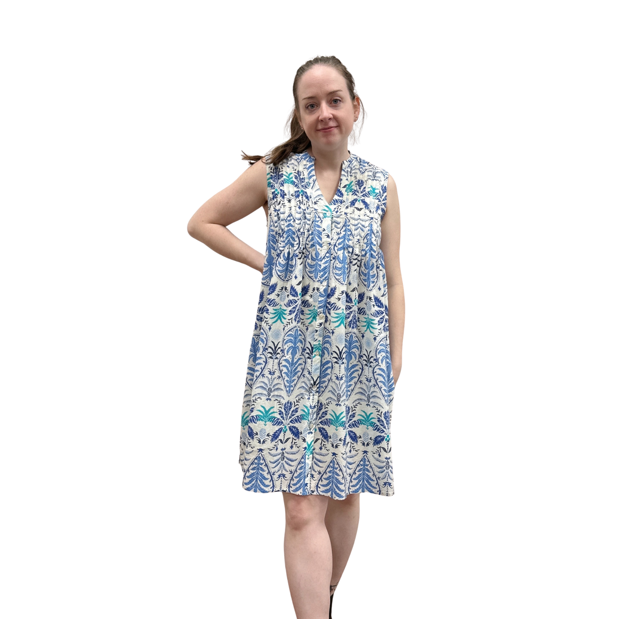 Woman wearing a sleeveless floral dress on a white background