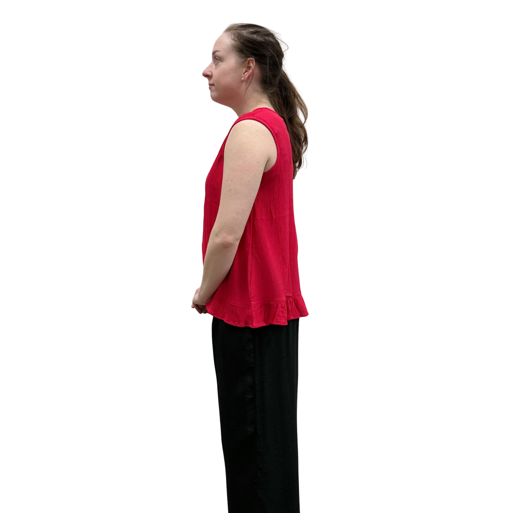 Woman wearing a red sleeveless top and black pants on a white background
