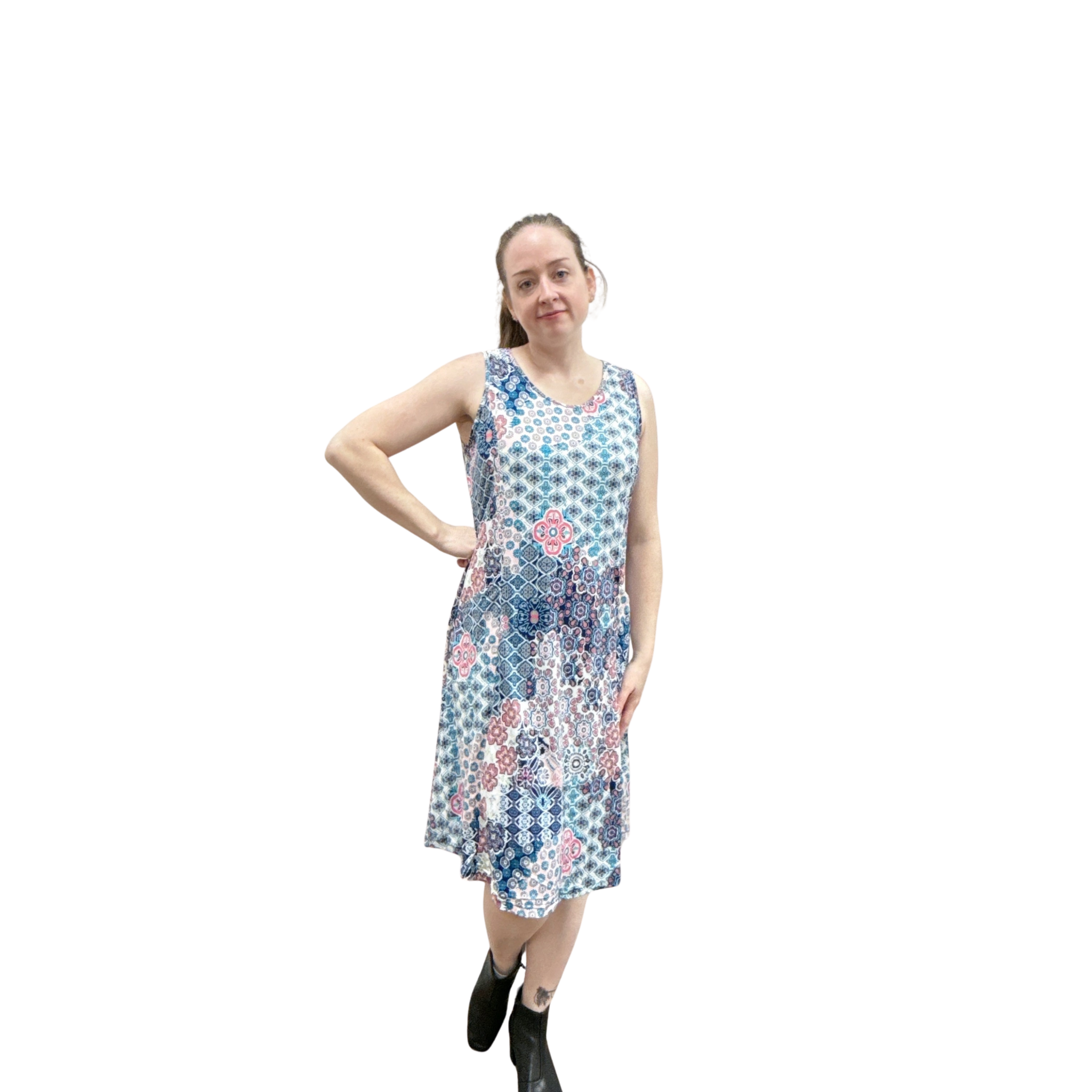 Woman wearing a patterned sleeveless dress on a white background