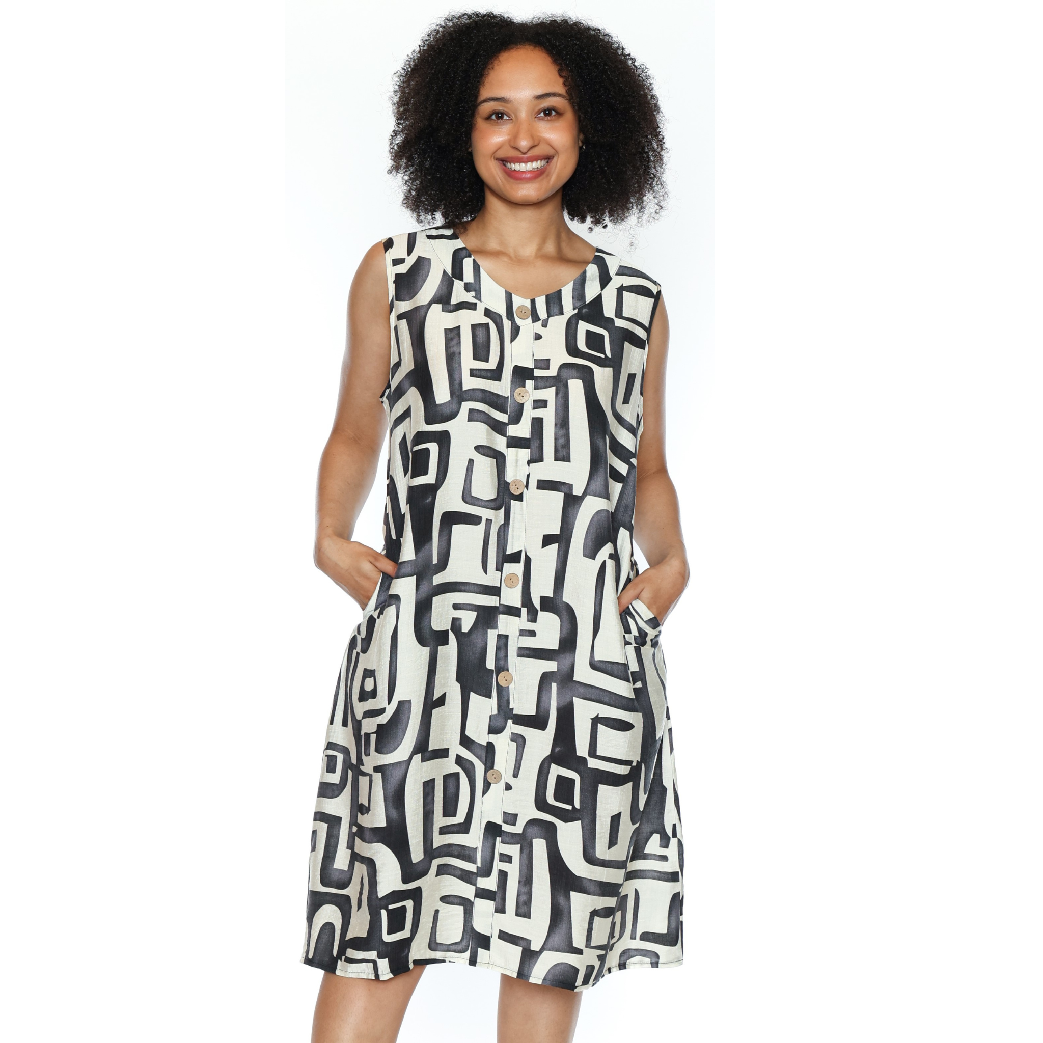 Woman wearing a sleeveless dress with a geometric pattern on a white background