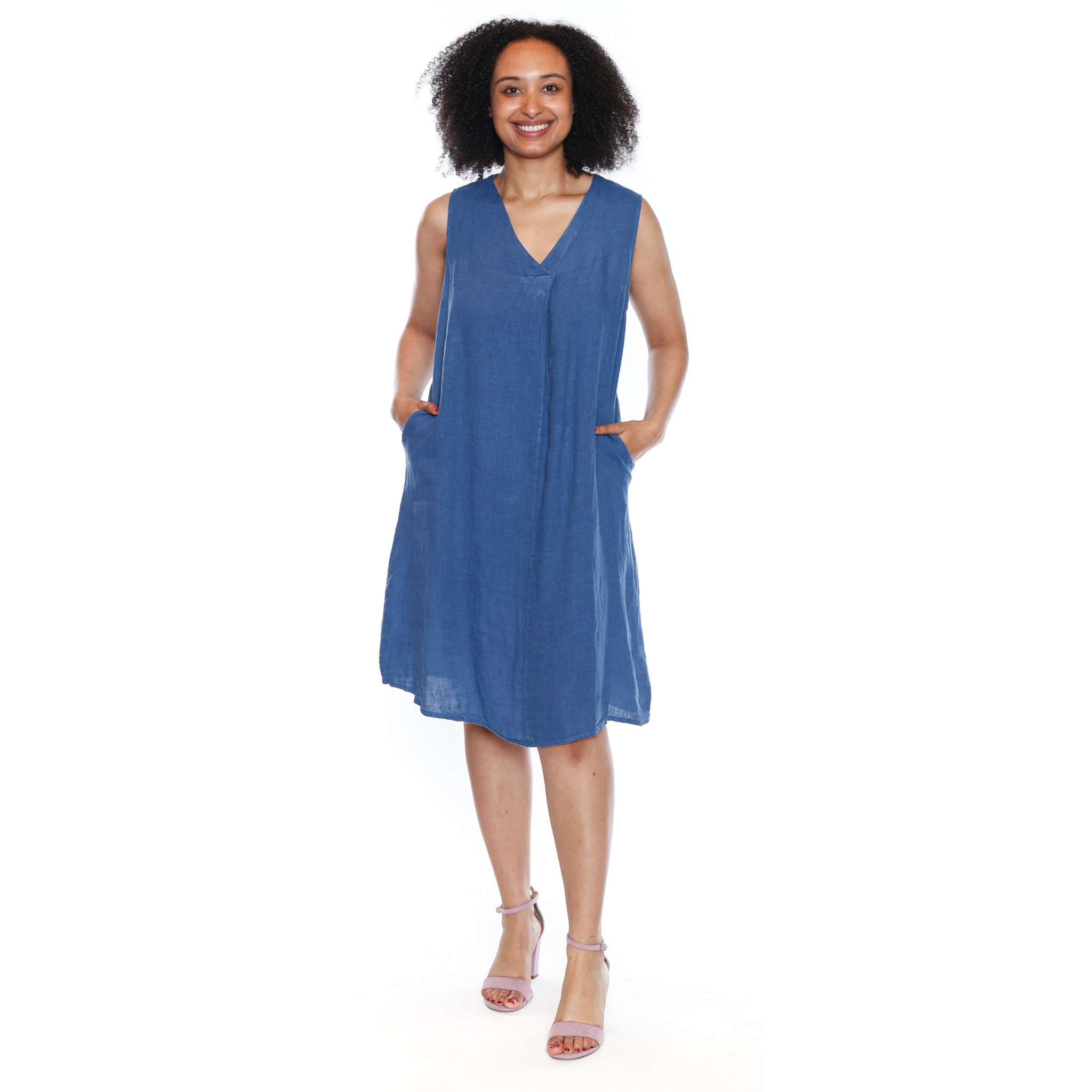 Woman wearing a blue sleeveless dress on a white background