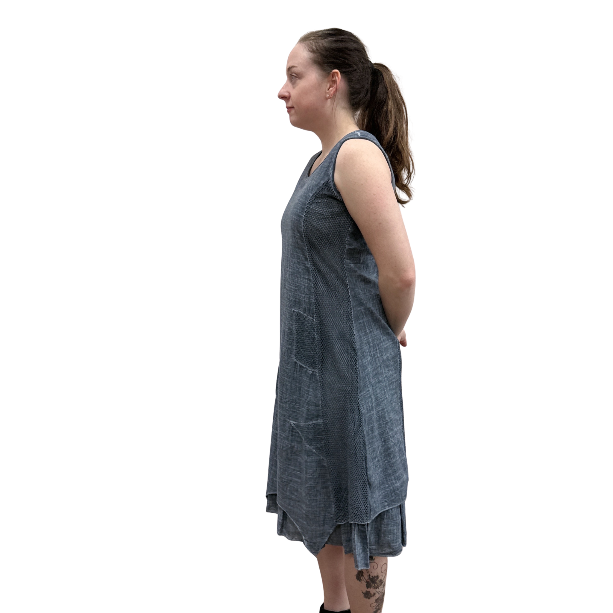 Woman wearing a blue denim dress on a white background