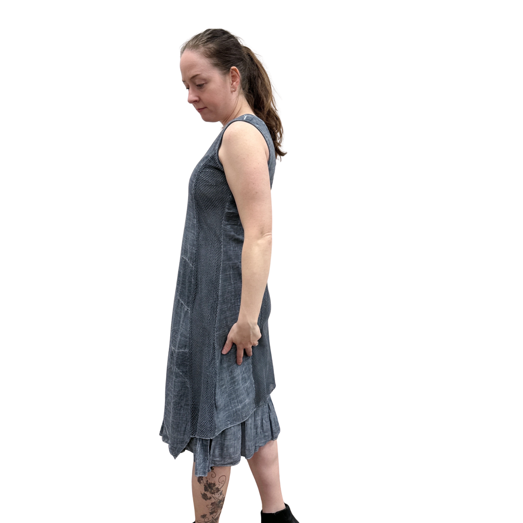 Woman wearing a sleeveless denim dress on a white background