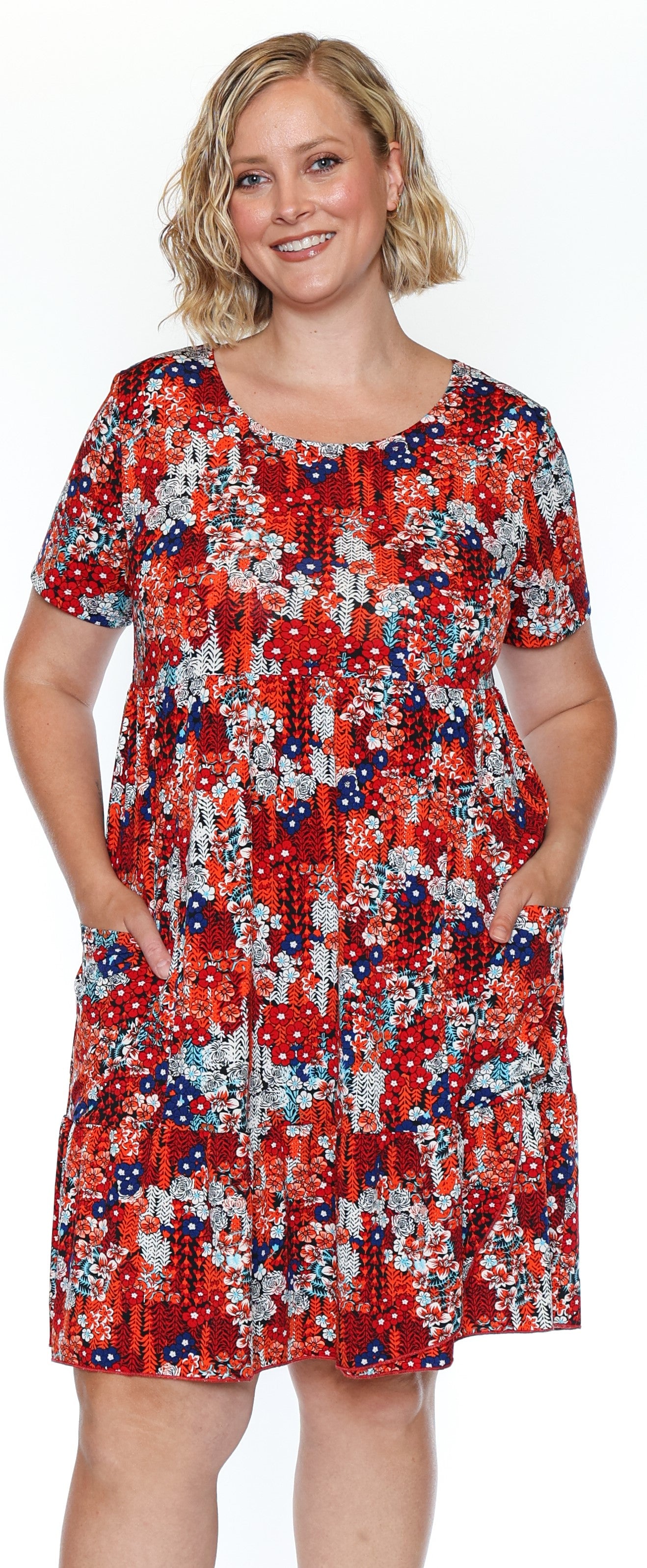 Woman wearing a red floral dress on a white background