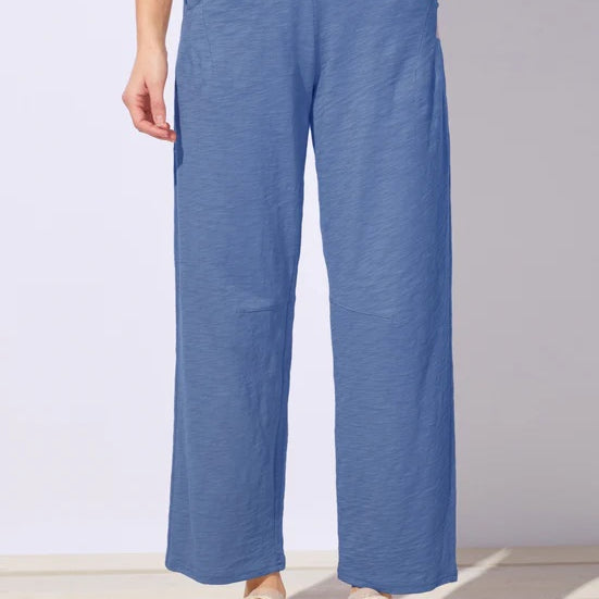 Person wearing blue pants with a white background