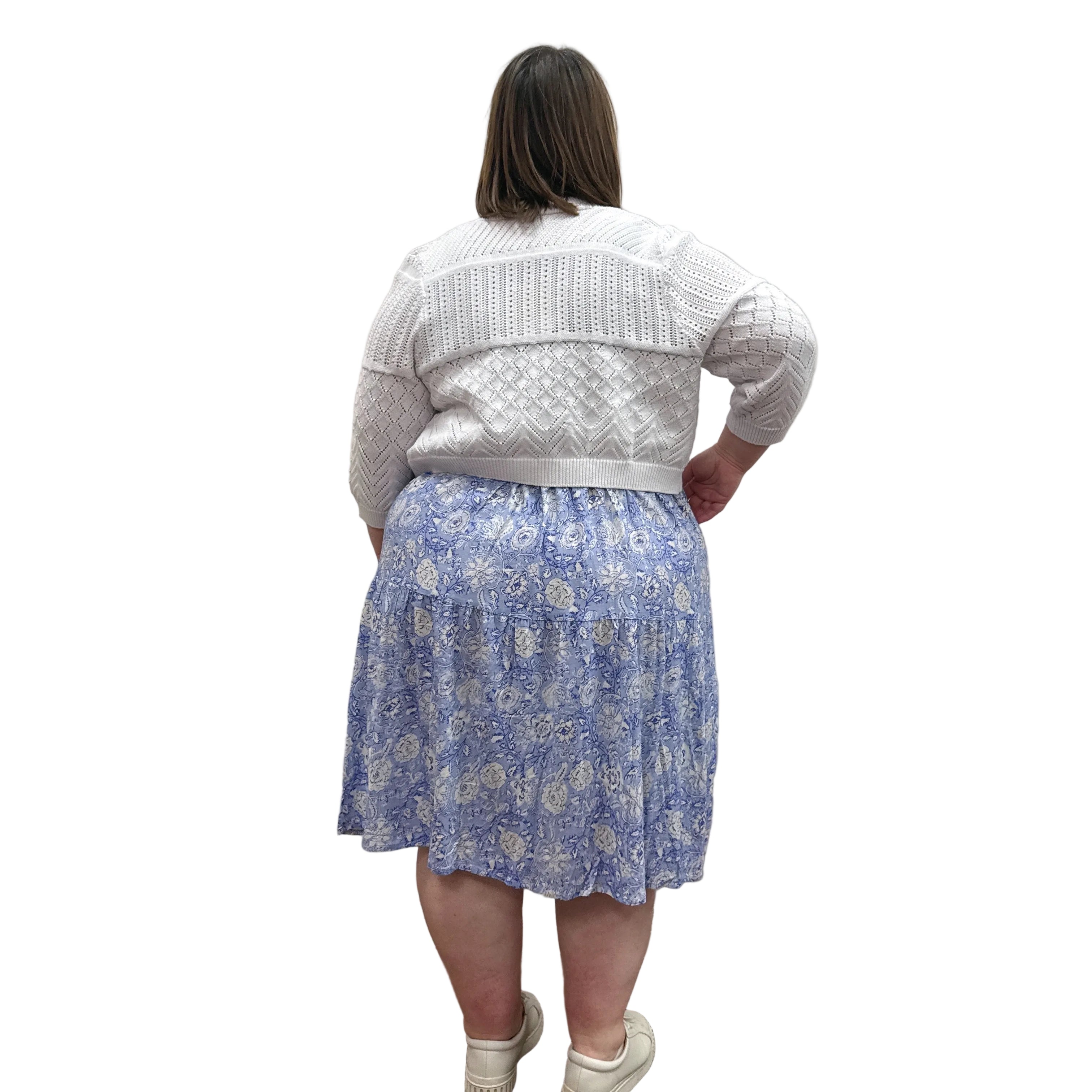 Woman wearing the Blue Sky Aldi Sweater in white over the blue Juni Dress on white background.