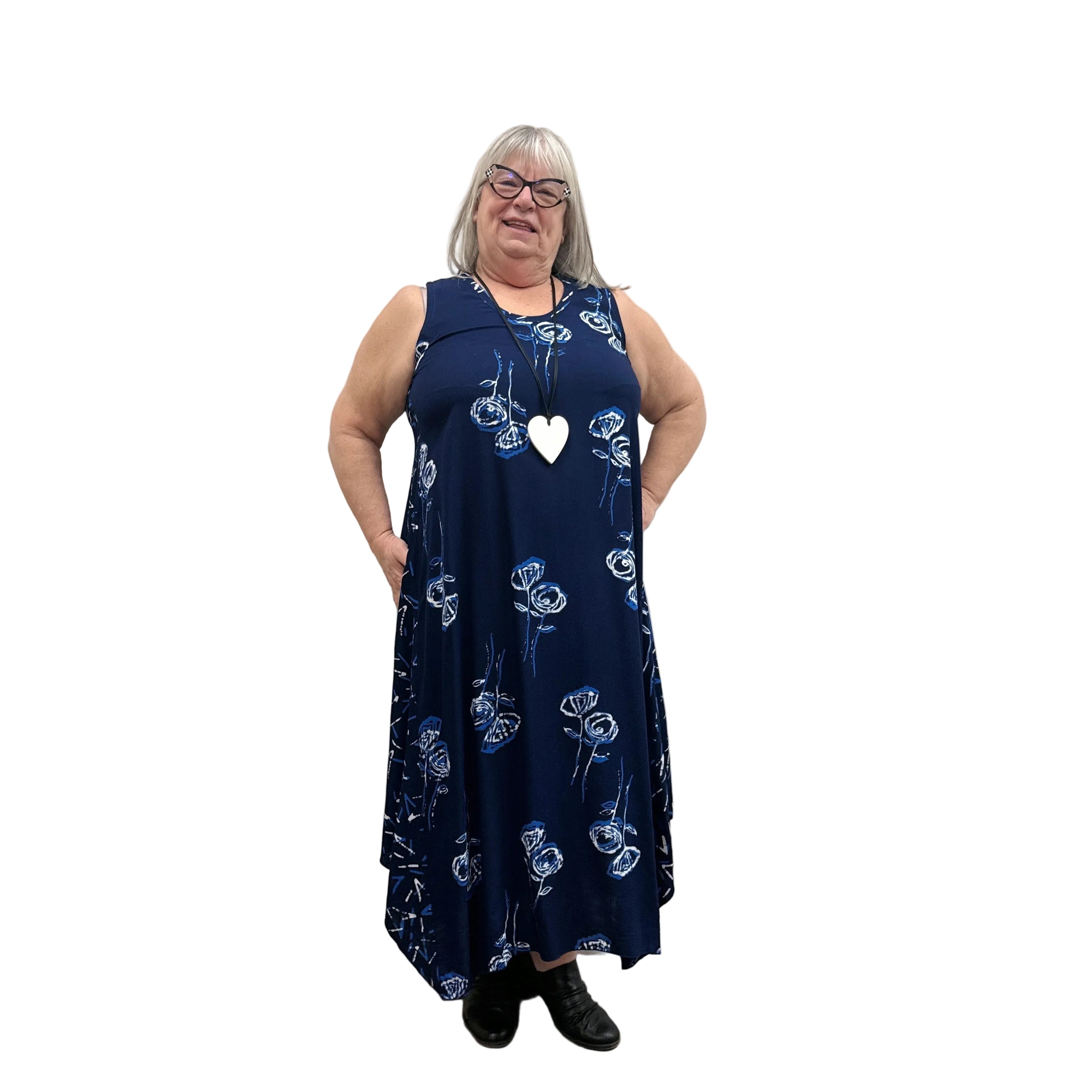 Woman wearing a navy floral Blue Sky Ari Dress on a white background.