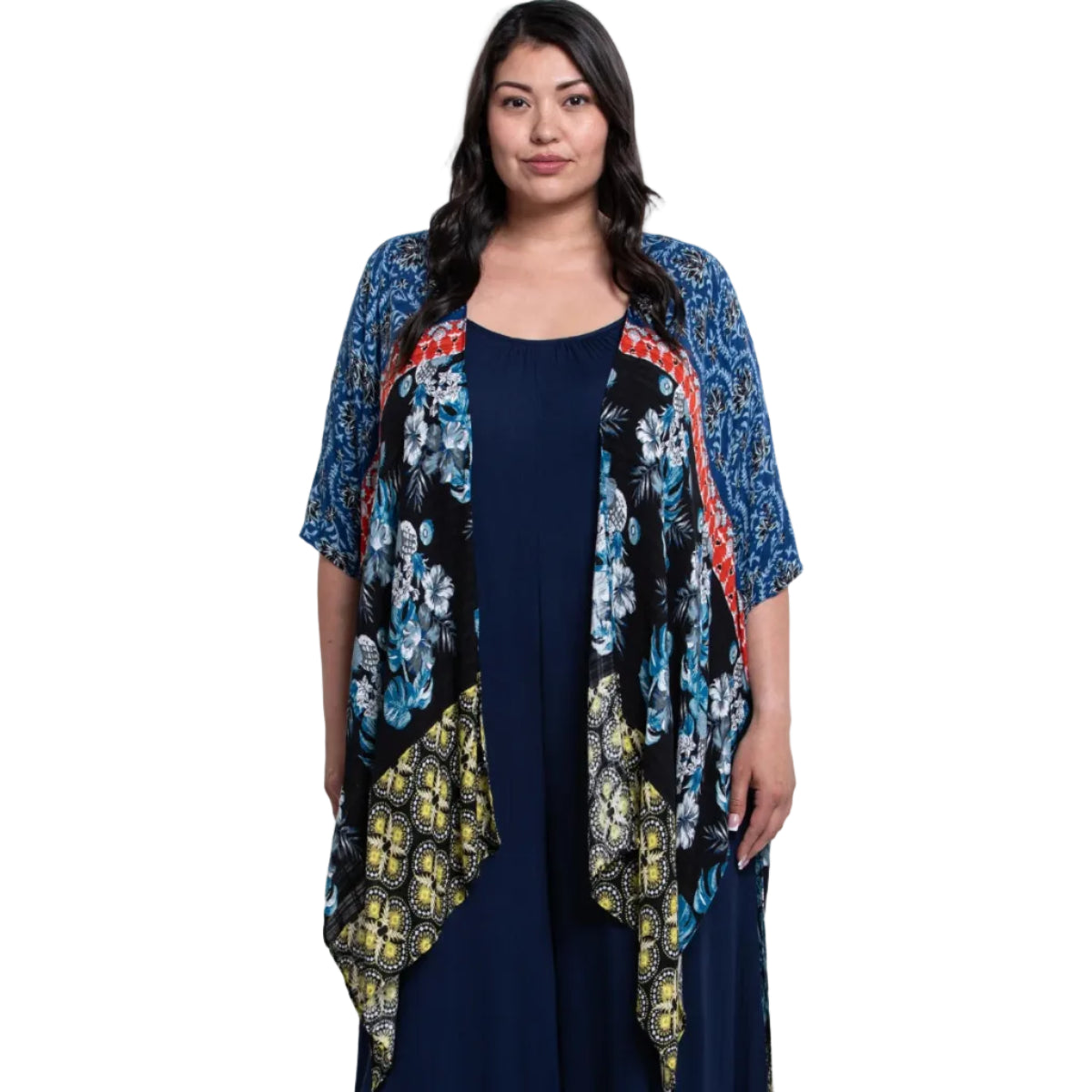 Woman wearing a floral kimono over a navy dress on a white background