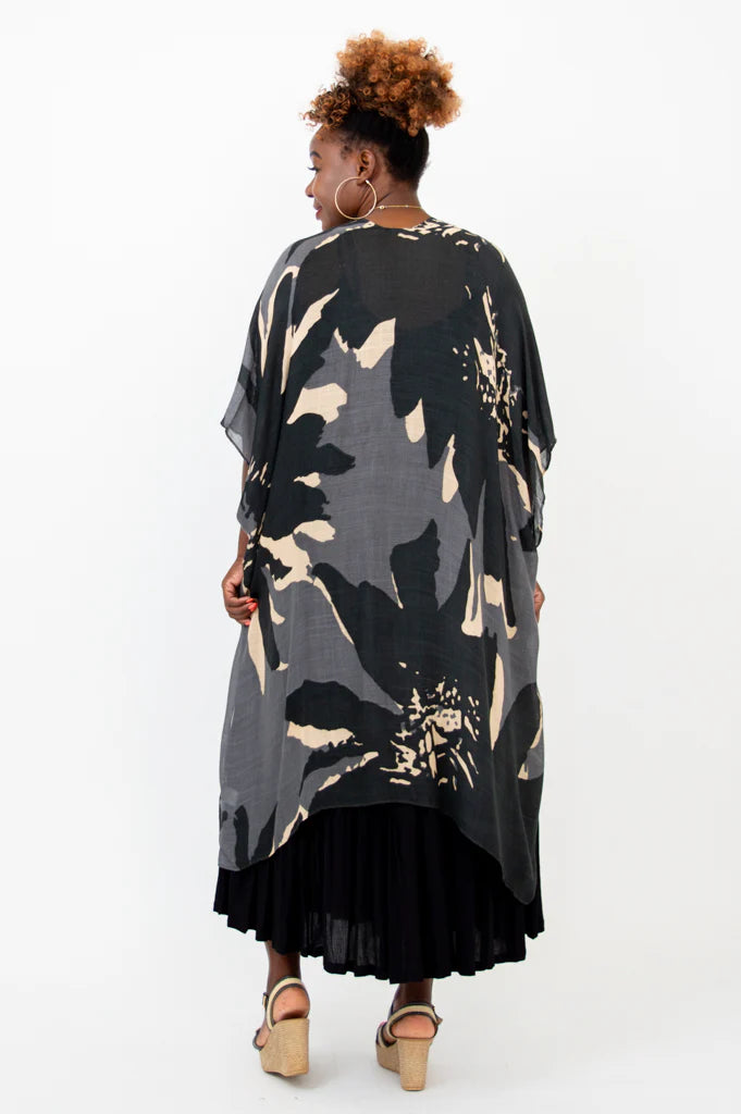 Woman wearing a black and gray patterned kimono-style garment on a white background