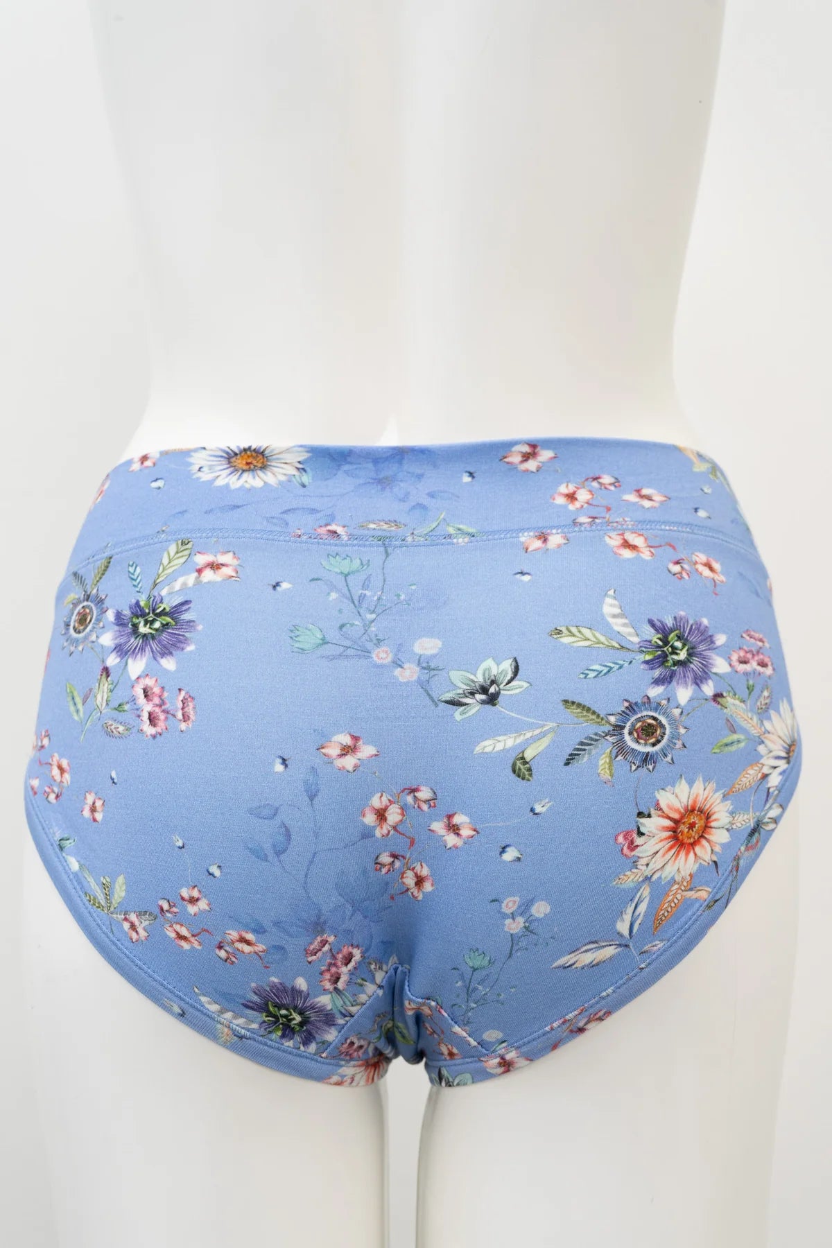 Floral-patterned blue underwear on a mannequin against a white background