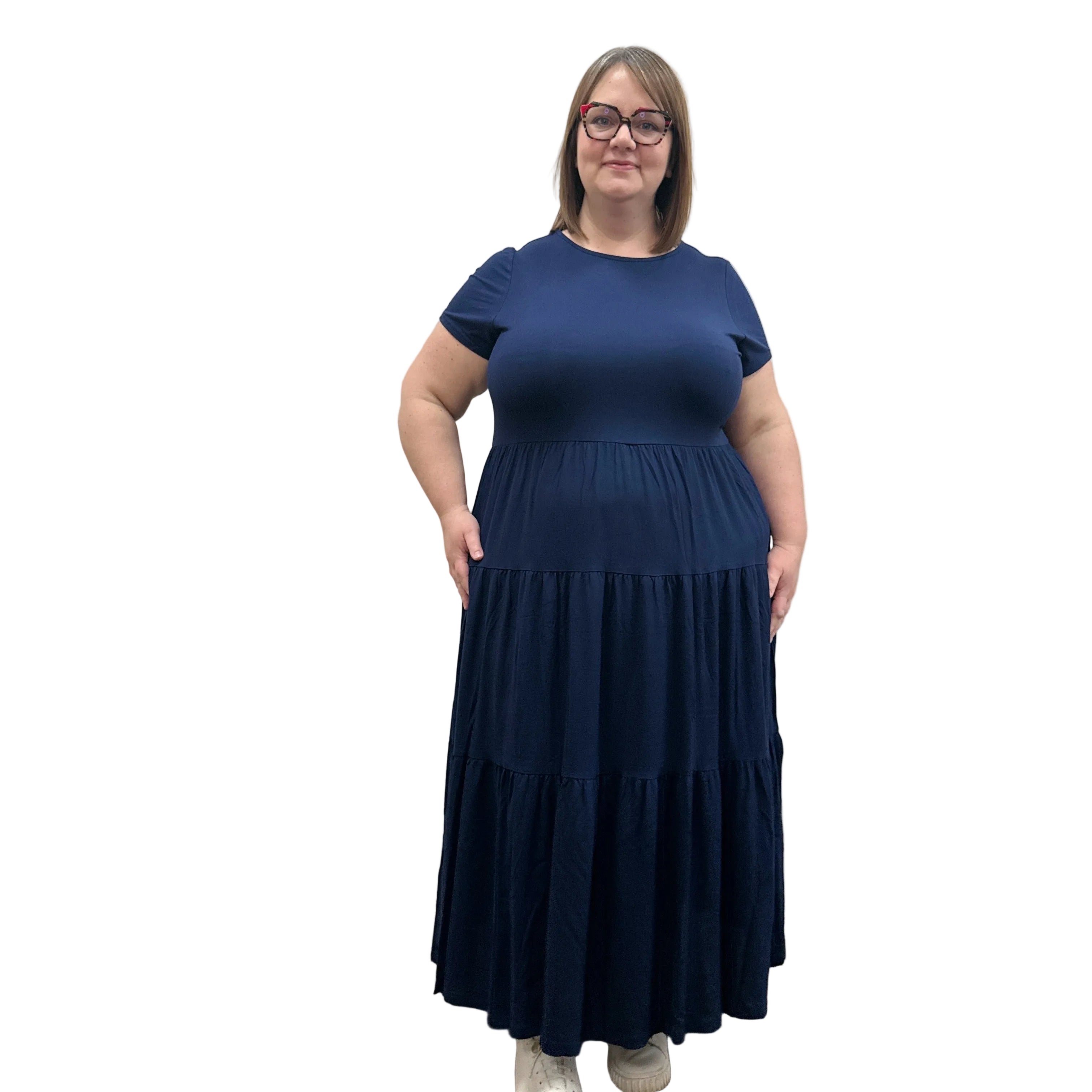 Woman wearing a dark blue Blue Sky Erin dress against a white background