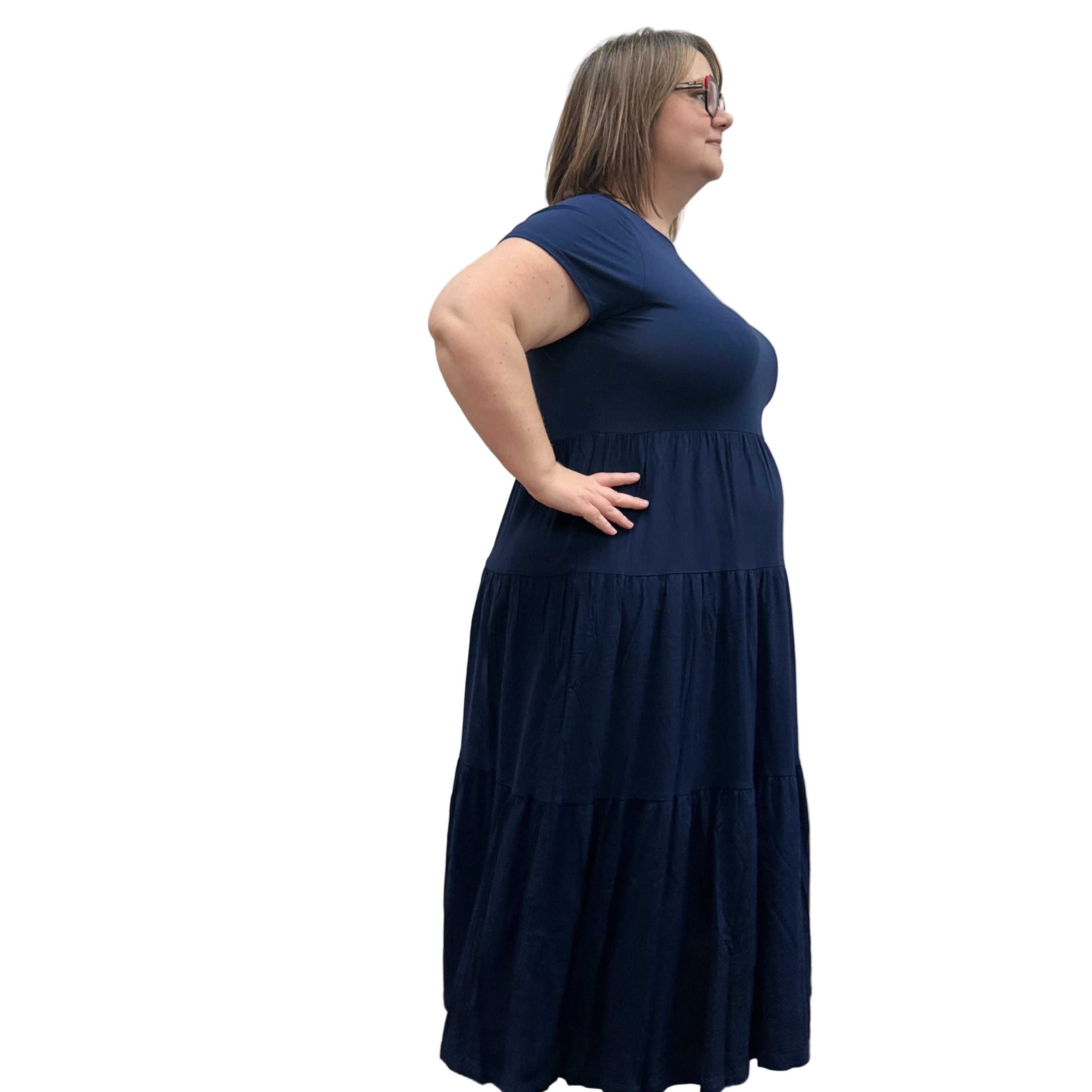 Woman wearing a dark blue Blue Sky Erin dress against a white background