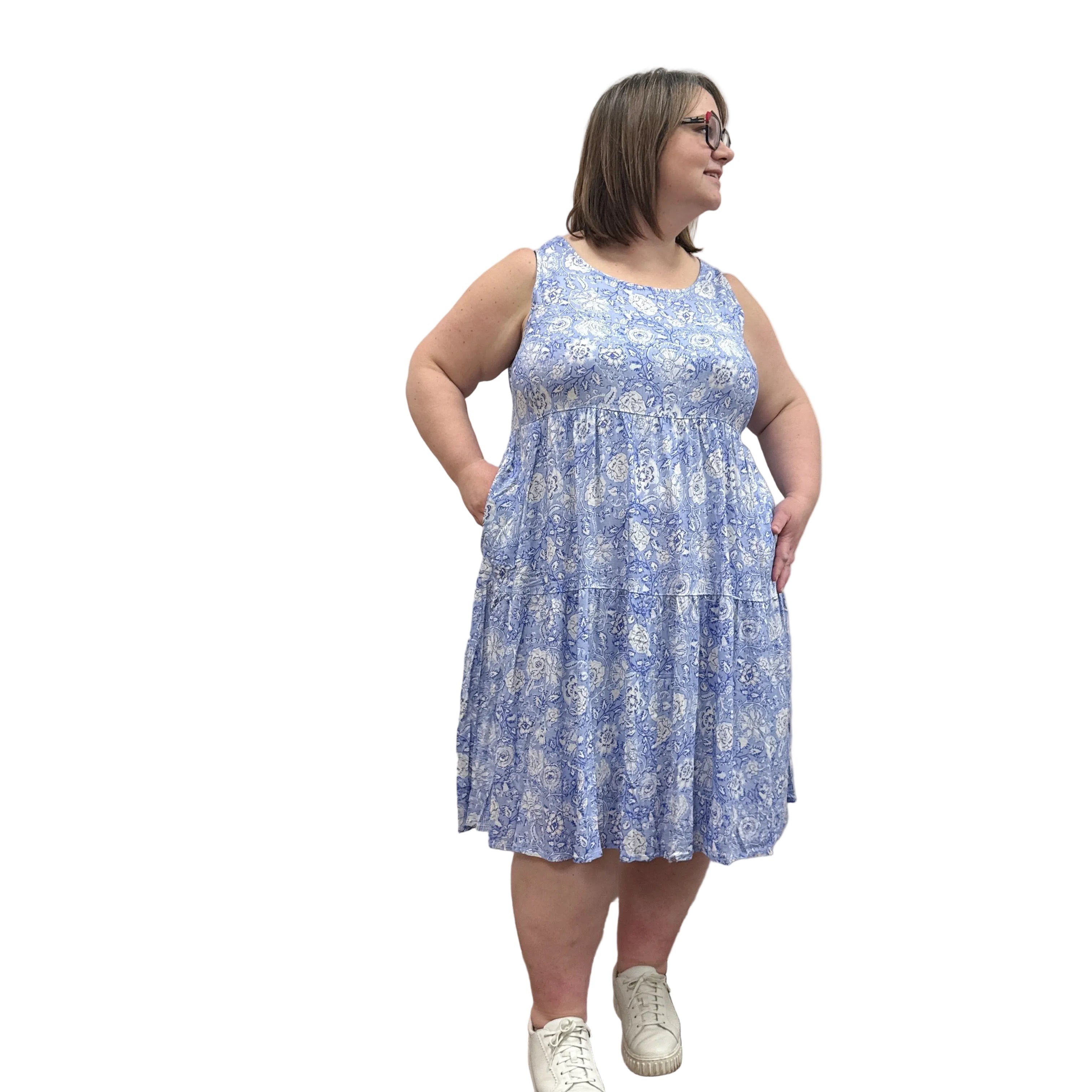 Woman wearing a patterned Blue Sky Juni Teatime Dress on a white background.