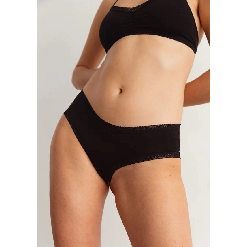 Blush The Micro Hipster in Black shown on model to display the low rise, boycut legs ad delicate lace trim.