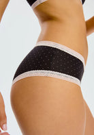 Side view of the "Micro Hipster" panty from Blush, showcasing its delicate and chic design. The panty is low-rise with cheeky coverage, adorned with a subtle polka dot pattern and elegant lace trim.