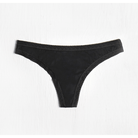 This image displays a sleek, black microfiber thong panty designed for everyday comfort. The thong features a delicate lace trim on the edges, a low-rise cut, and back shirring for a smooth finish.