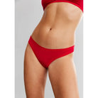 This image features a vibrant red microfiber thong panty, designed to provide a second-skin feel and comfort. The panty is low-rise with a delicate lace trim, enhancing its elegant appeal.