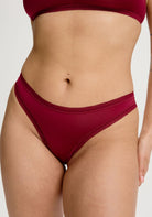 Red underwear worn by a person on a plain background