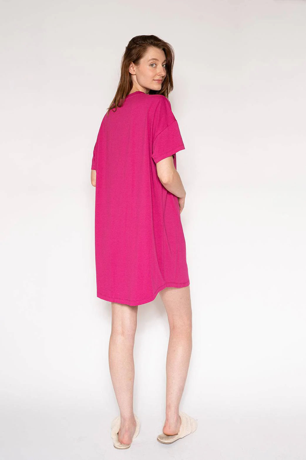 Woman wearing a pink dress on a white background