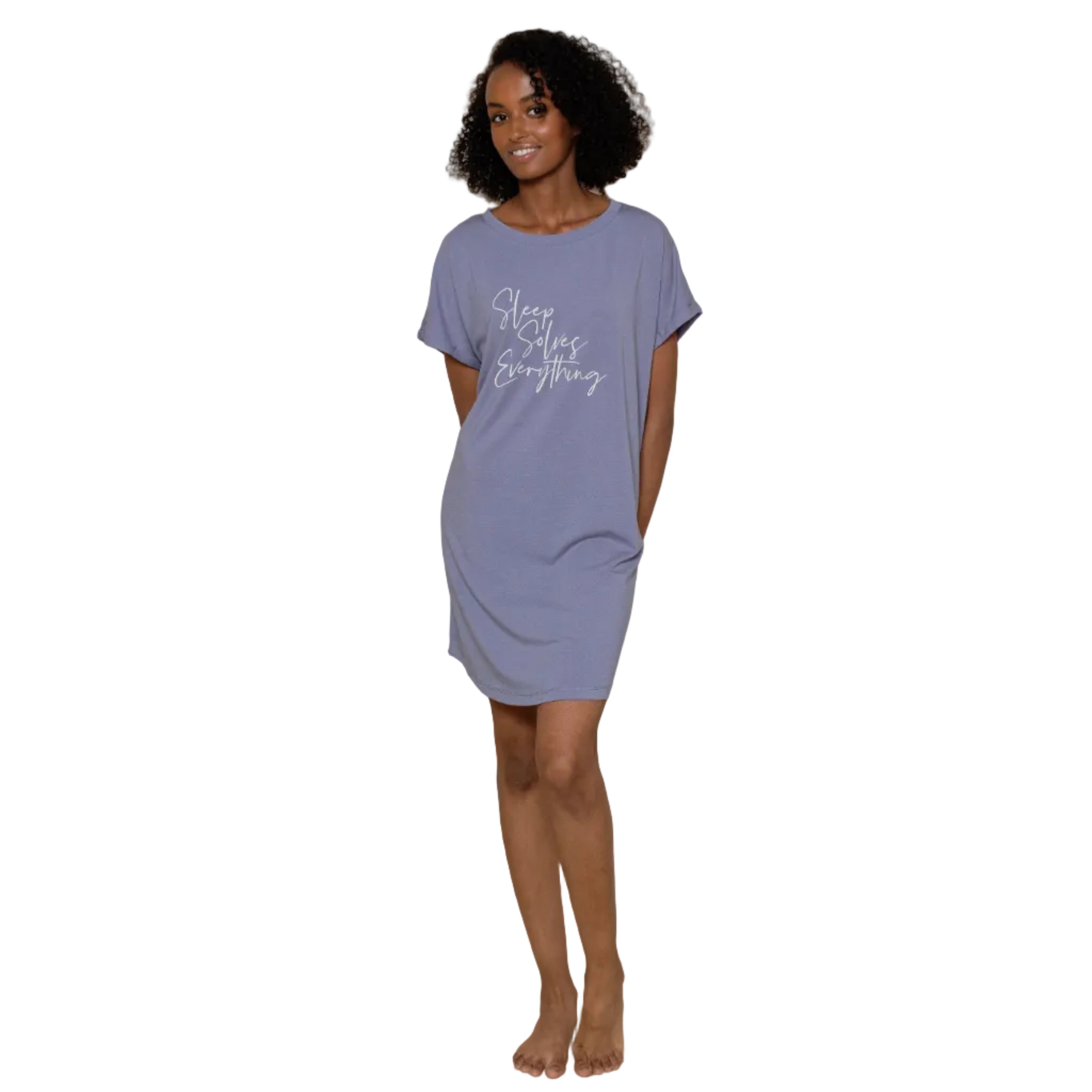 Woman wearing a purple nightshirt with text on it against a neutral background