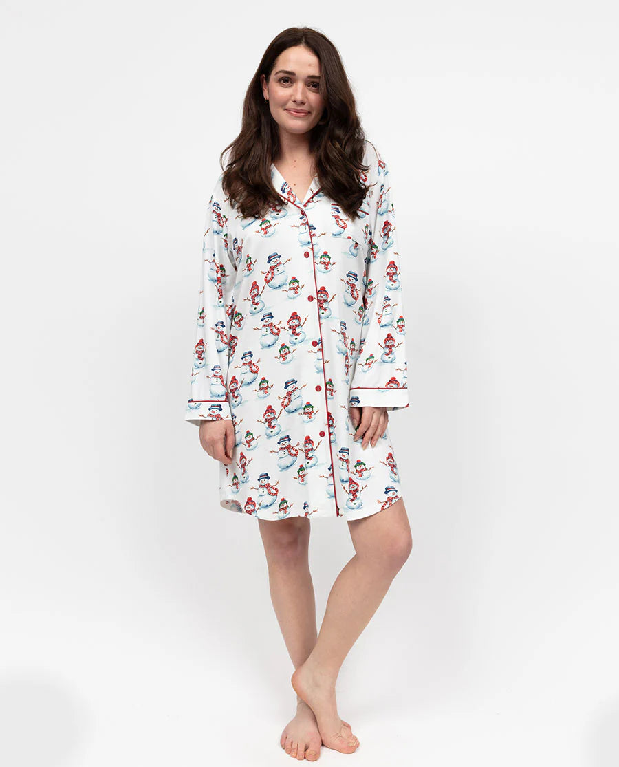 Woman wearing a long-sleeve pajama top with a pattern on a white background