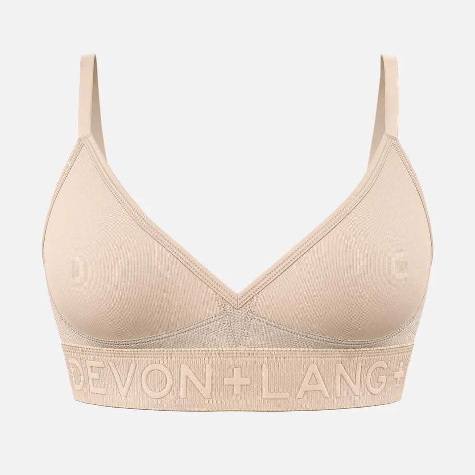 A beige bralette against a white background