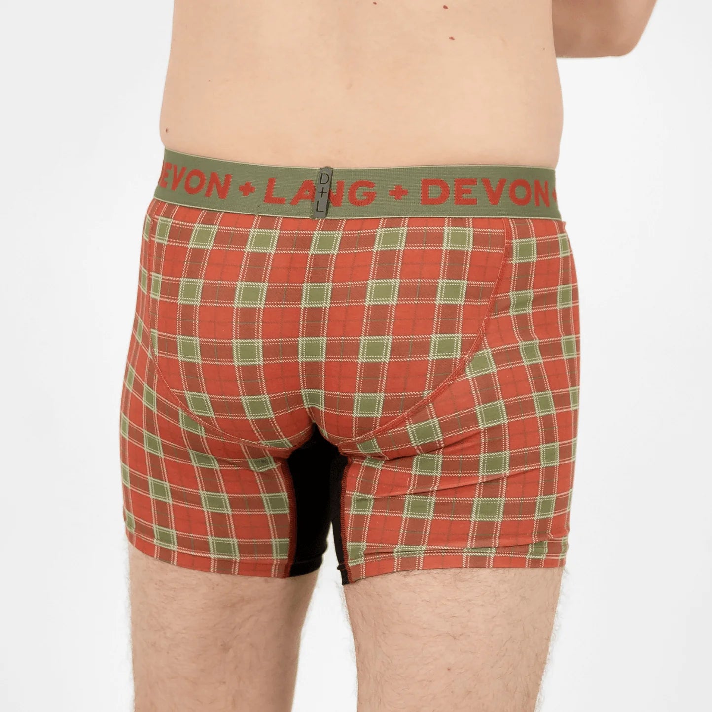 Red plaid boxer briefs with green waistband featuring 'Devon + Lang' brand on a white background.