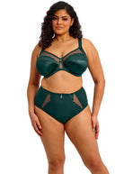 Woman wearing a green lingerie set on a white background
