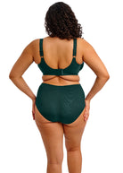 Person wearing a green swimsuit on a white background