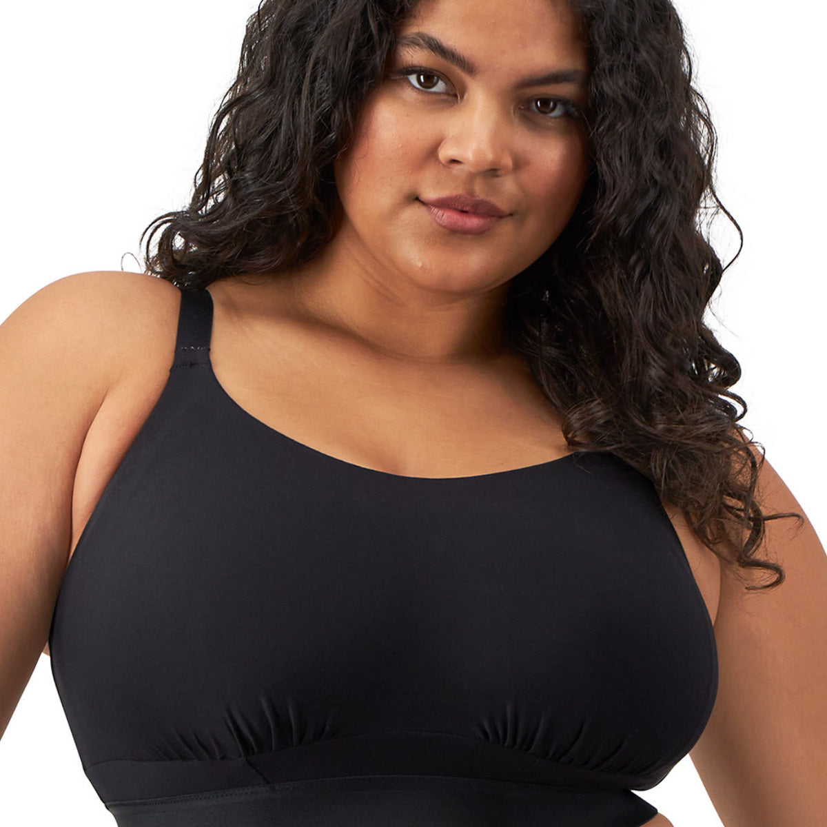 Woman wearing a black wireless bra on a white background